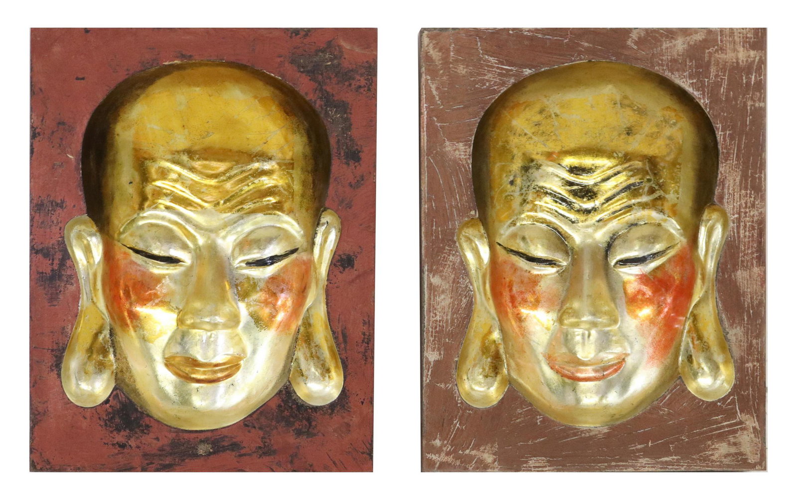 (2) CONTEMPORARY GILT BUDDHA MASK MOLD WALL ART: (pair) Contemporary cast composite wall plaques, gilt Buddha mask molds, with flushed cheeks and polychrome border, signed illegibly at back, approx 12.25"h, 9.5"w, 3"d; 3lbs total Start Price: $50.00