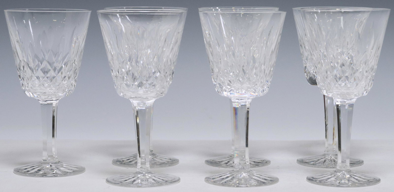 (7) WATERFORD LISMORE CRYSTAL CLARET WINE GLASSES: (lot of 7) Waterford cut crystal claret wine glasses, in the "Lismore" pattern, bowl with vertical cuts, multi-sided stem, acid-etched mark underfoot, approx 5 7/8"h, 3"diam; 4.5lbs total Start Price: