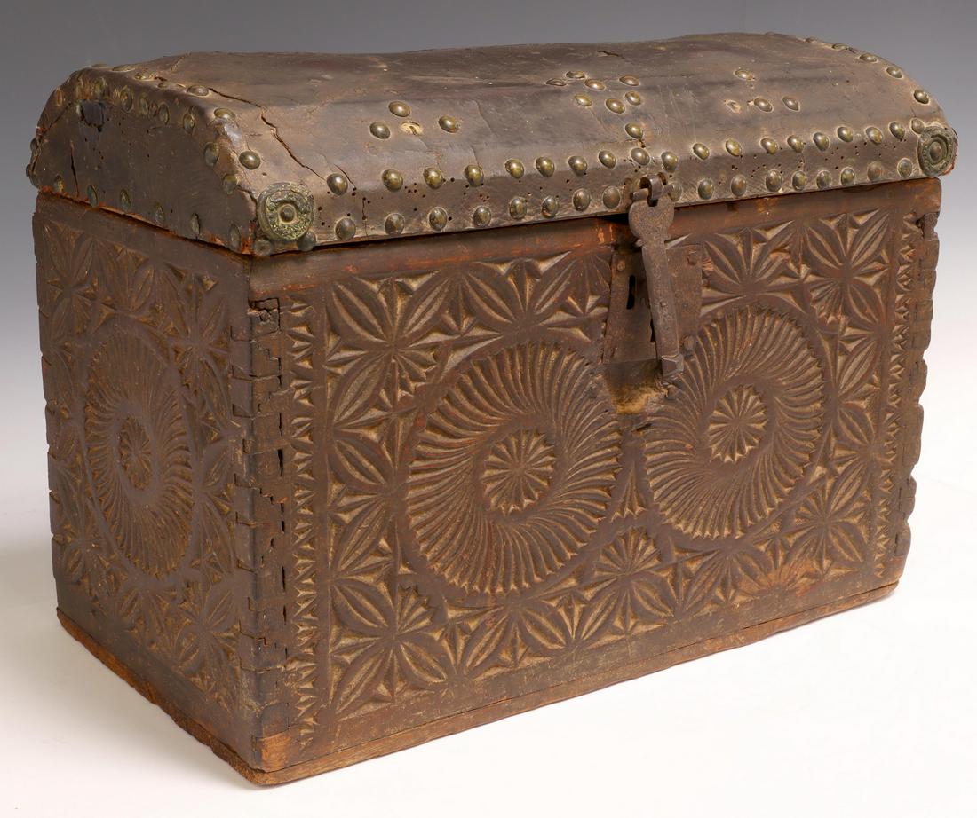 SPANISH COLONIAL LEATHER & CARVED CHEST, 18TH C.: Spanish Colonial travel chest, 18th c., cedar case with dovetail construction, having leather clad domed lid, with varied nailhead trim, over case with chip carved pinwheel design, approx 13.5"h, 18"w