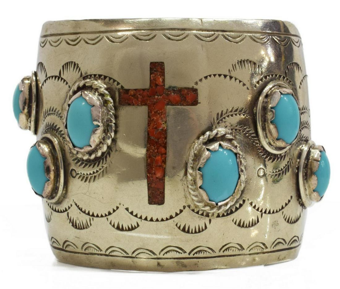 LARGE NATIVE AMERICAN SILVER RED CORAL CROSS CUFF: Large Native American silver (content unknown) cuff bracelet, stamped designs, central red coral mosaic inlay cross, six turquoise cabochons, approx 2.5"w, interior: (end to end) approx 6"l, gap: appr