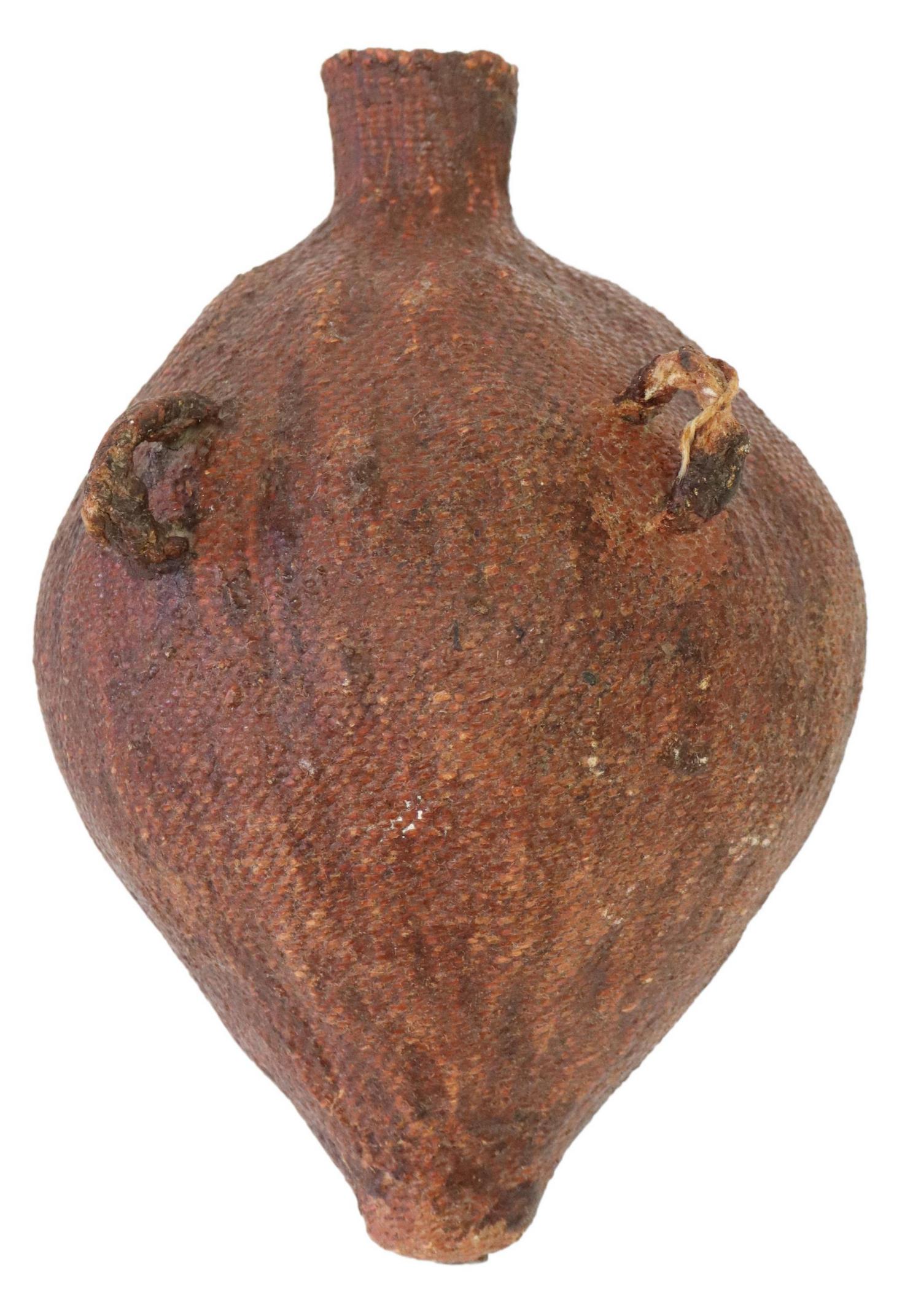 NATIVE AMERICAN PAIUTE PITCH-COVERED WATER BOTTLE: Native American pitch-covered water bottle, Paiute, c.1920-1950s, having dual braided twine handles, approx 11"h, 8"diam, 0.75lbs**Provenance: The Dr. David Beer Collection of Native American Artifact