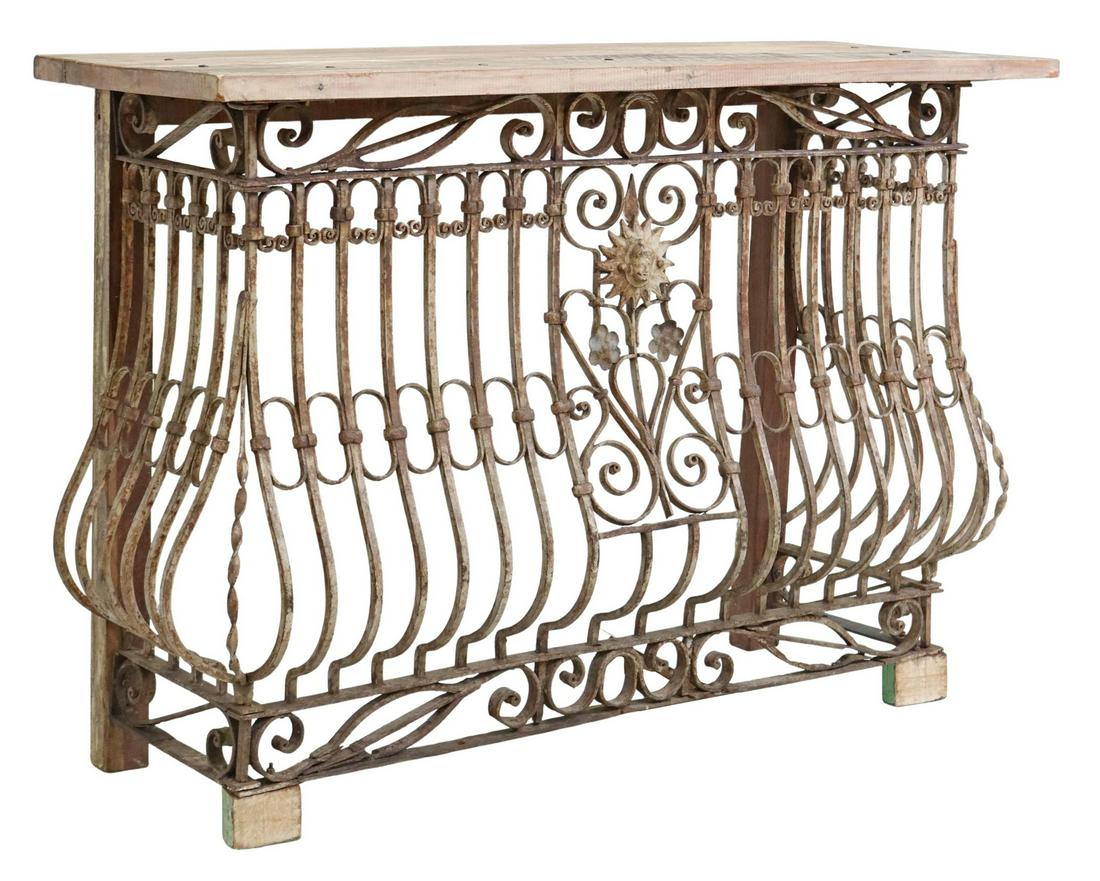 LARGE RUSTIC WROUGHT IRON CONSOLE TABLE: Large Rustic console table, 20th c., having rectangular wood top, over wrought iron base with scrolled accents, rising on wood block feet, approx 42.25"h, 60"w, 22"d Start Price: $200.00