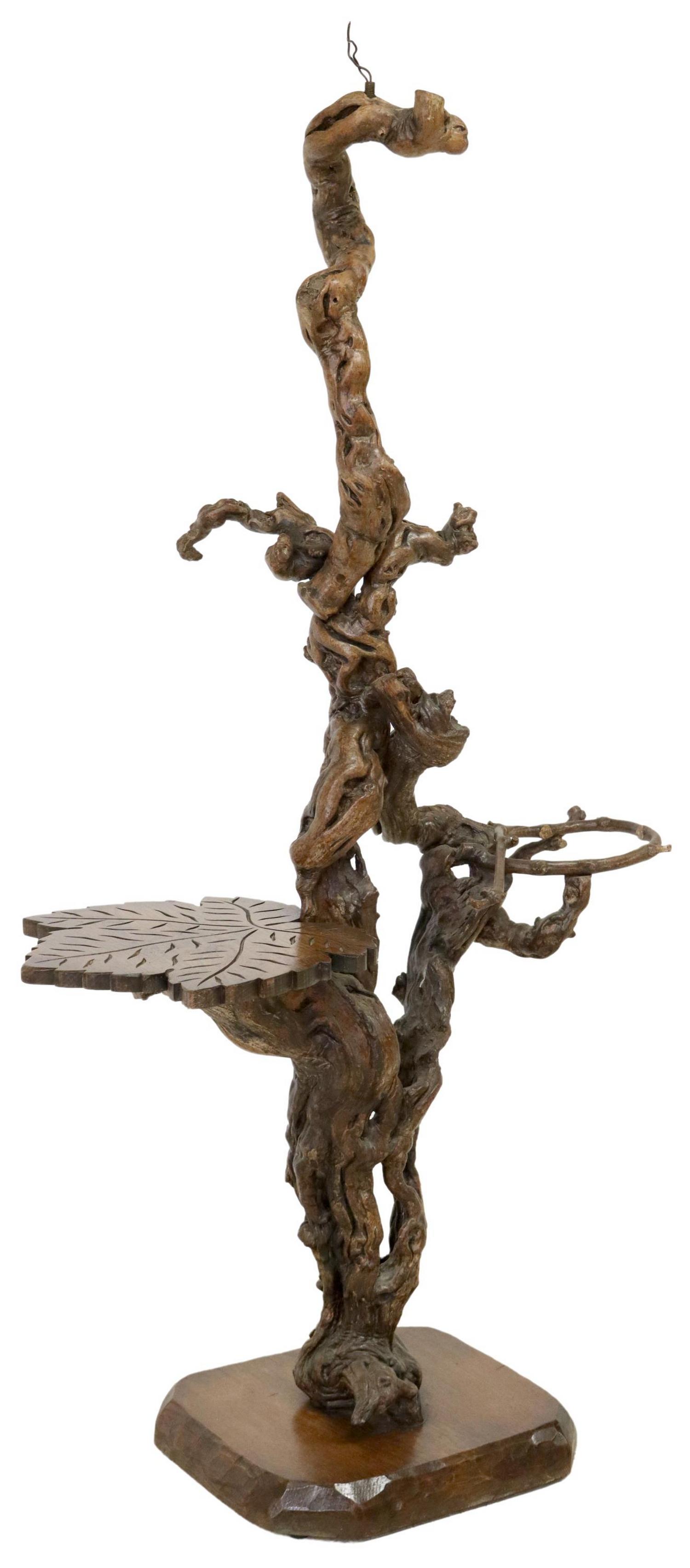 RUSTIC TWISTED ROOT FLOOR LAMP/ HALL STAND: Rustic hall floor lamp, 20th c., single light, over twisted root standard, issuing carved leaf table to one side, and umbrella holder to the other, ending on chamfered base, in need of wiring, approx 