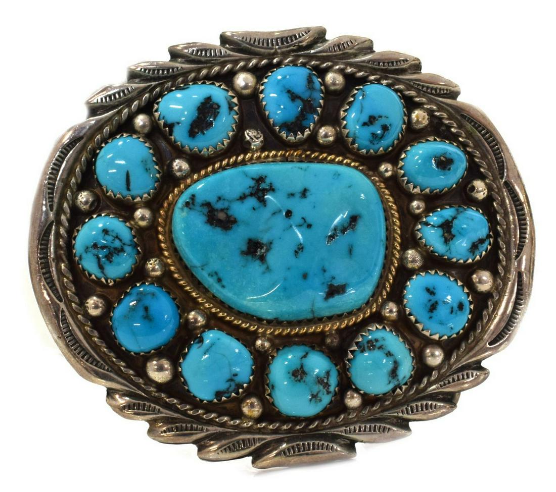 NATIVE AMERICAN YAZZIE STERLING TURQUOISE BUCKLE: Native American sterling silver belt buckle, signed Y, likely Johnson Yazzie or Celina Yazzie (Navajo/ Dine, 20th c.), oval form, central turquoise stone surrounded by twelve additional bezel-set turq
