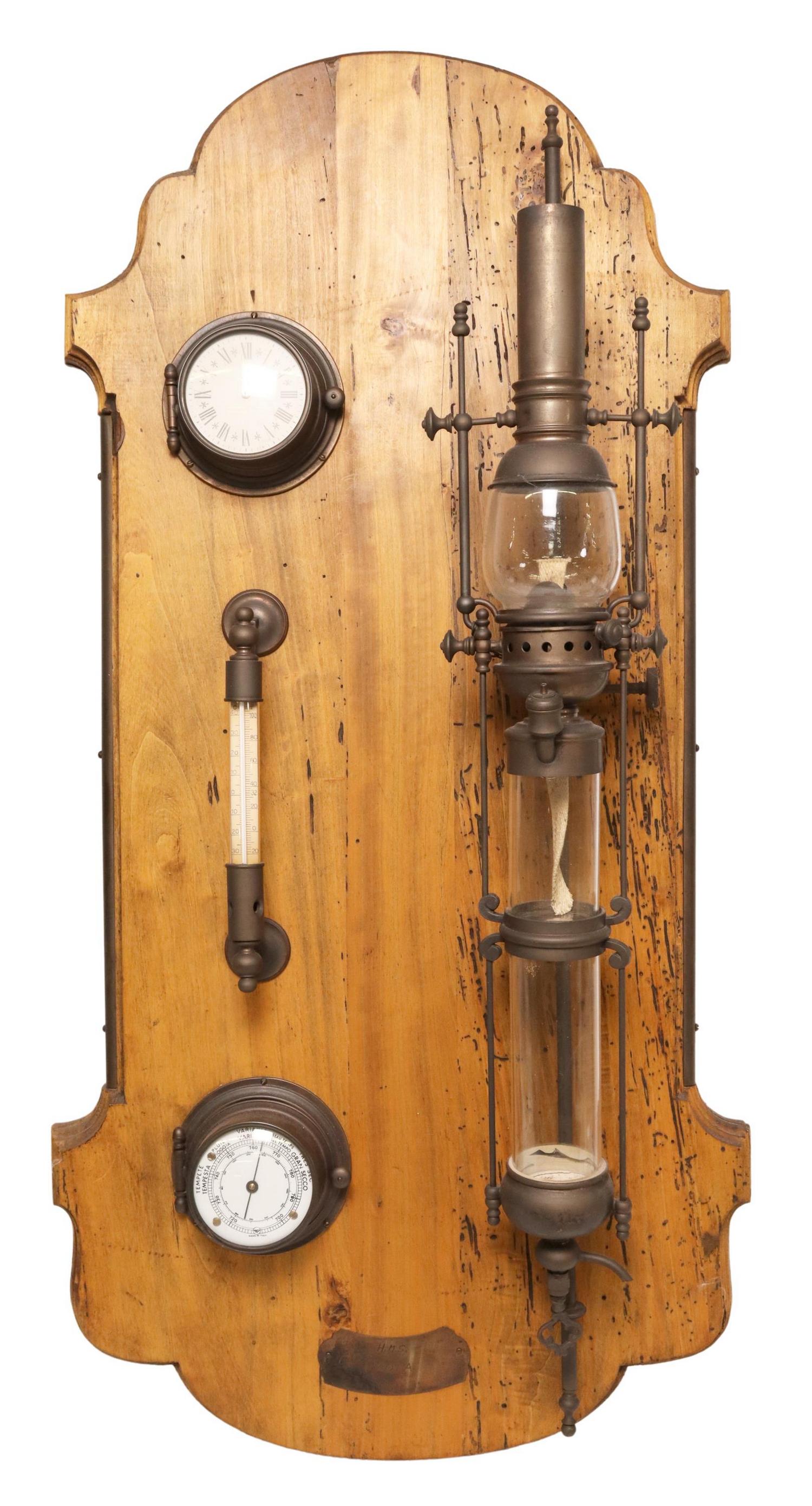 HMS LYDIA SHIP MOUNTED LANTERN & BAROMETER: Frigate ship mounted lantern and barometer, shaped wood back board, metal plaque engraved HMS Lydia, approx 38.25"h, 17.75"w, 7"d Start Price: $200.00