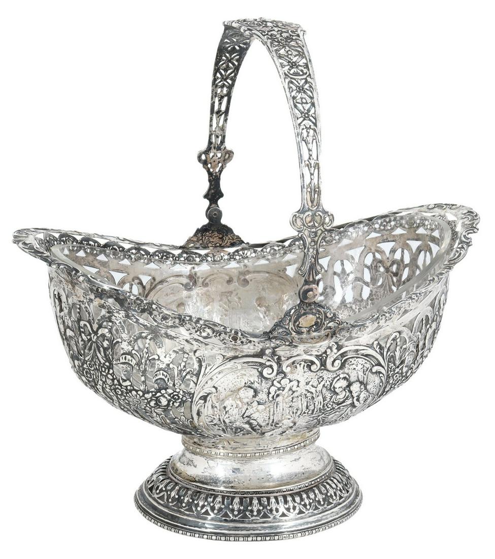 GERMAN ROCOCO REVIVAL 800 SILVER PIERCED BASKET: German 800 silver centerpiece basket, in the Rococo taste, bail handle, reticulated frame with swags of floral garlands, figural reserves with shepherd and shepherdesses, colorless glass liner, approx