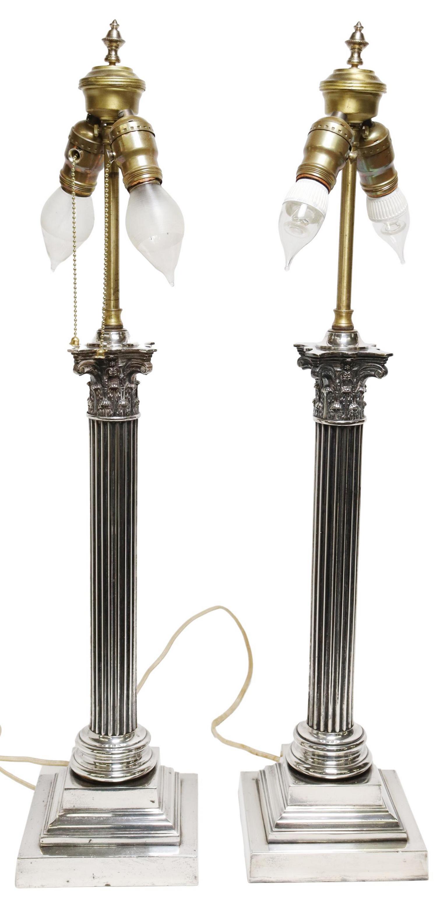 (2) SILVERPLATE CORINTHIAN COLUMN TABLE LAMPS: (pair) Neoclassical style silverplate two-light table lamps, standard modeled as a Corinthian column, rising on a stepped square base, would benefit from re-wiring, (one) socket lacking pull chain, ap