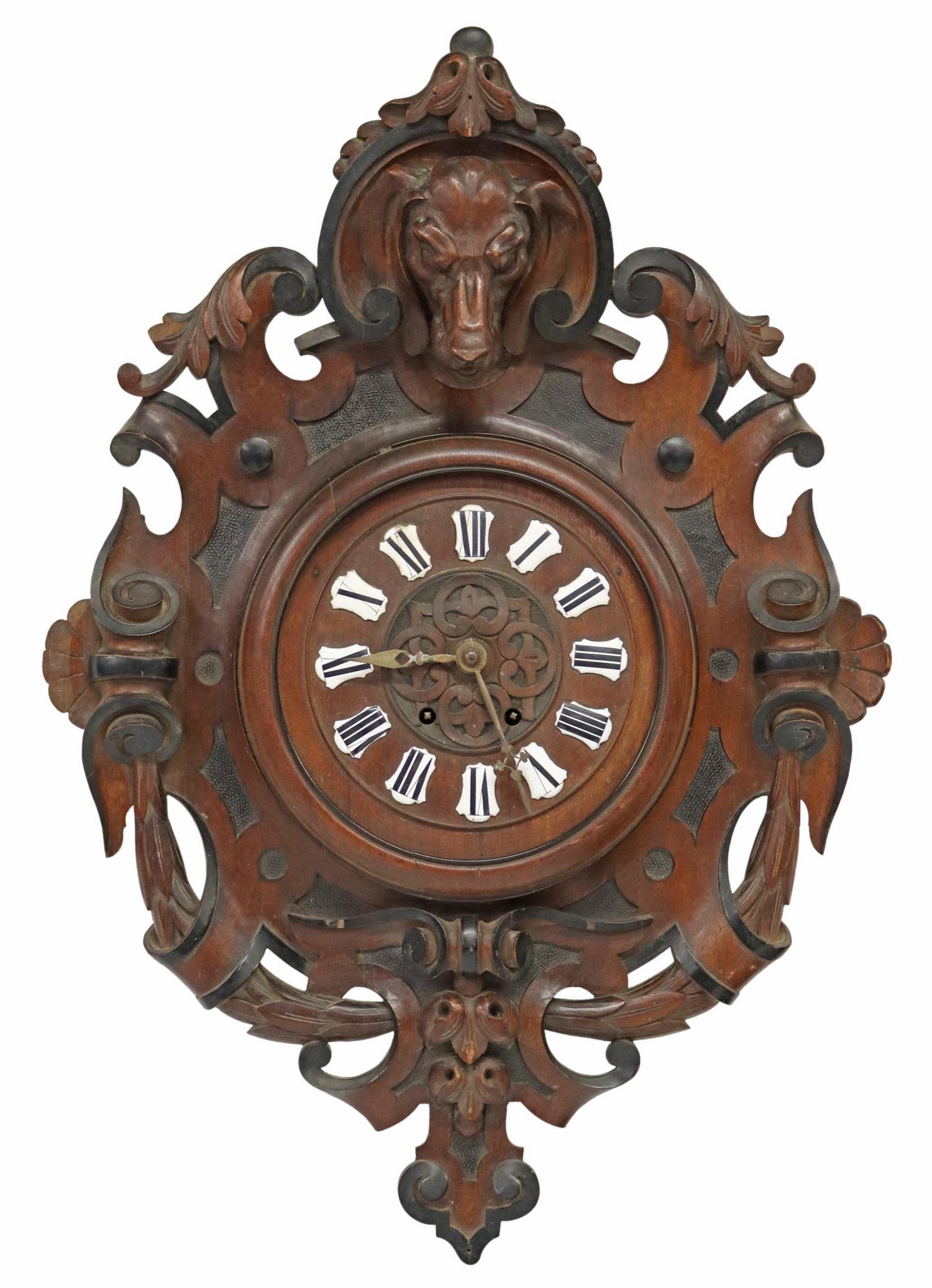BLACK FOREST HOUND CARVED WALL CLOCK, 19TH C.: Black forest carved walnut wall clock, late 19th c., figural hound carved crest, over foliate and scroll frame, dial with enamel numerals, time-and-strike movement, retaining pendulum, approx 26"h, 18