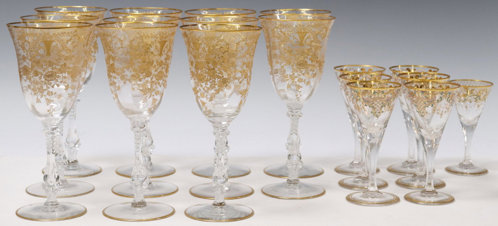 (18) CRYSTAL & GILT STEMWARE, CAMBRIDGE ROSE POINT: (lot of 18) Crystal and gilt stemware, including: (11) Cambridge water goblets, in the "Portia" gold encrusted pattern, with the 3121 stem, (one) with chip to rim, approx 8.25"h, 3 5/8"diam; (7) cordi