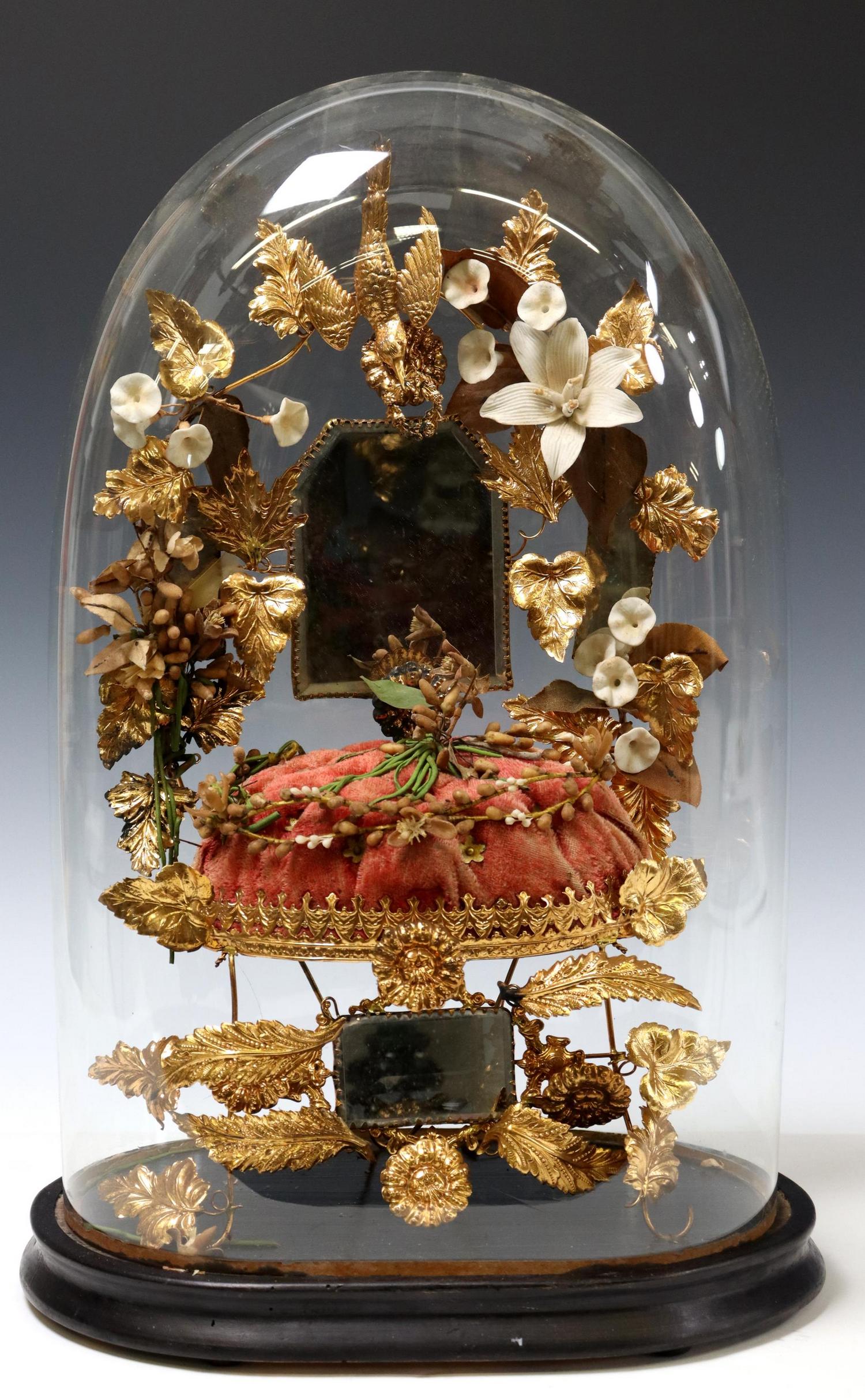 FRENCH GLOBE DE MARIEE/ BRIDE'S GLOBE: French globe de mariee/ bride's globe, late 19th c., glass cloche/ dome on ebonized base, enclosing gilt metal frame, small mirror plates, wedding tiara, tufted cushion, overall: approx 19.5"h, 13"w, 
