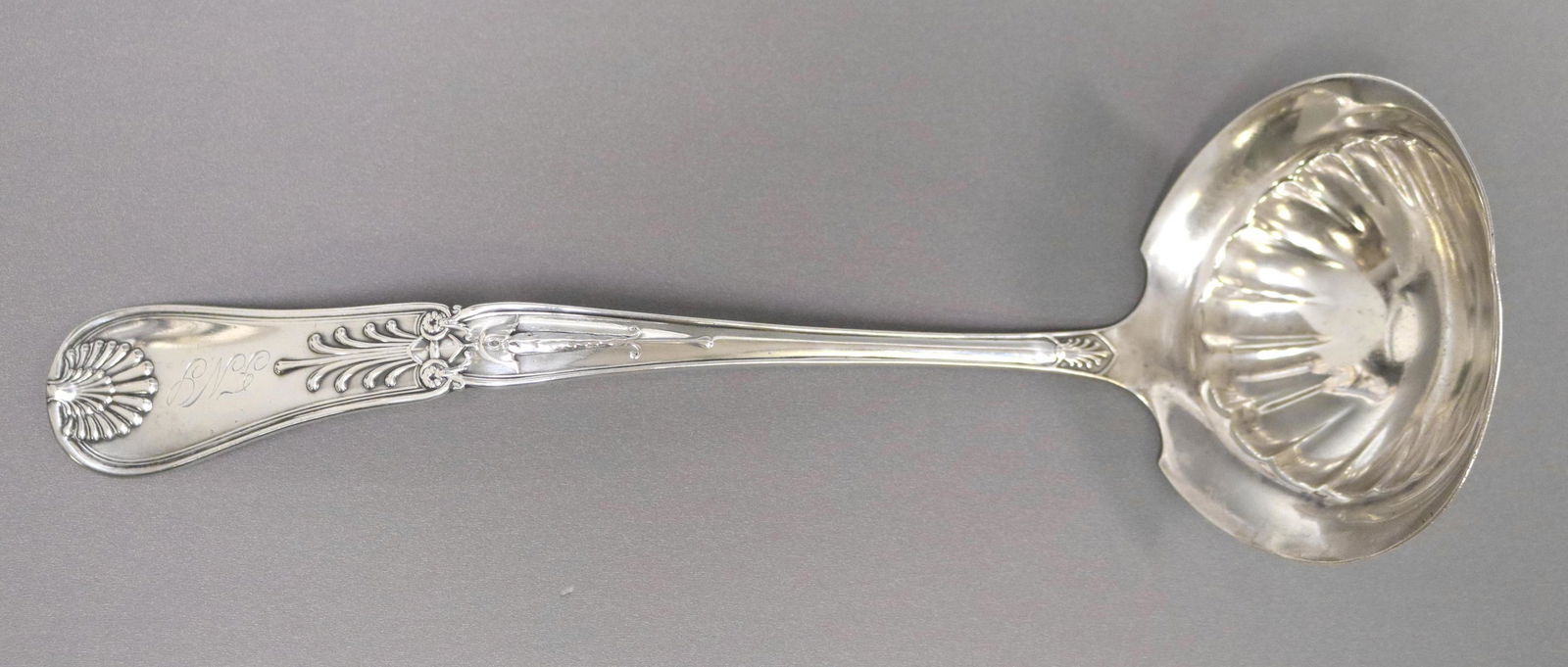 GORHAM STERLING SILVER 'KINGS I" PATTERN LADLE: Gorham sterling silver ladle, "Kings I" pattern, triple monogram on handle, small nicks to bowl edge, approx 13"l, 7.68ozt Start Price: $80.00
