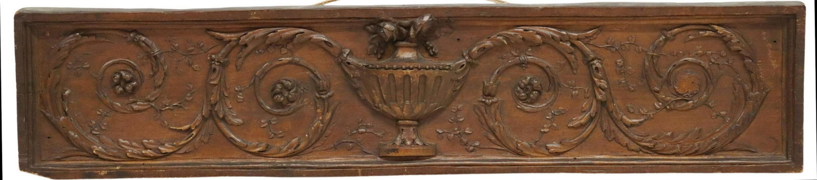 NEOCLASSICAL STYLE CARVED WALNUT OVERDOOR PANEL: Neoclassical style carved walnut overdoor panel/ architectural element, reverse incised H.A. 14.V.M. 1913, classical urn framed by foliate scrolls, small losses to carving, loss to lower left corner, 