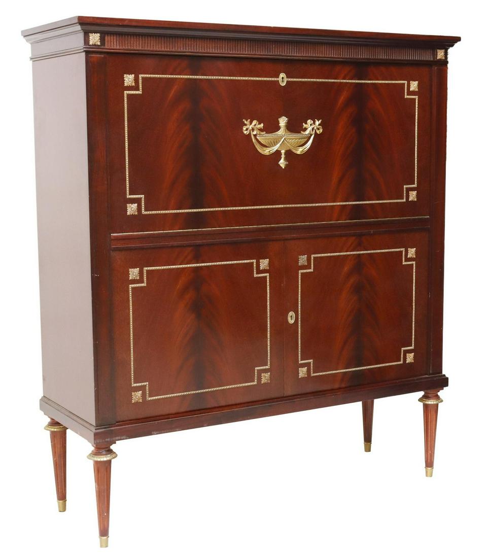 FRENCH LOUIS XVI STYLE MAHOGANY FALL-FRONT CABINET: French Louis XVI style flame mahogany cabinet, 20th c., the case ornamented with gilt metal mounts, drop-front, opening to lighted and divided interior, over two lower cabinets, rising on tapered and 