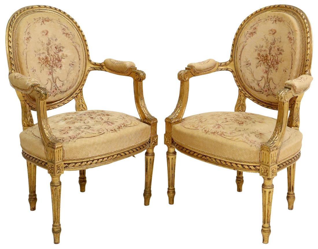 (2) FRENCH LOUIS XVI STYLE GILTWOOD FAUTEUILS: (pair) French Louis XVI style giltwood oval back armchairs, late 19th c., having floral tapestry, padded arms, rising on tapered ribbed legs, approx 37"h, 23.75"w, 19.5"d, seat height: 18.5"h **Note: 