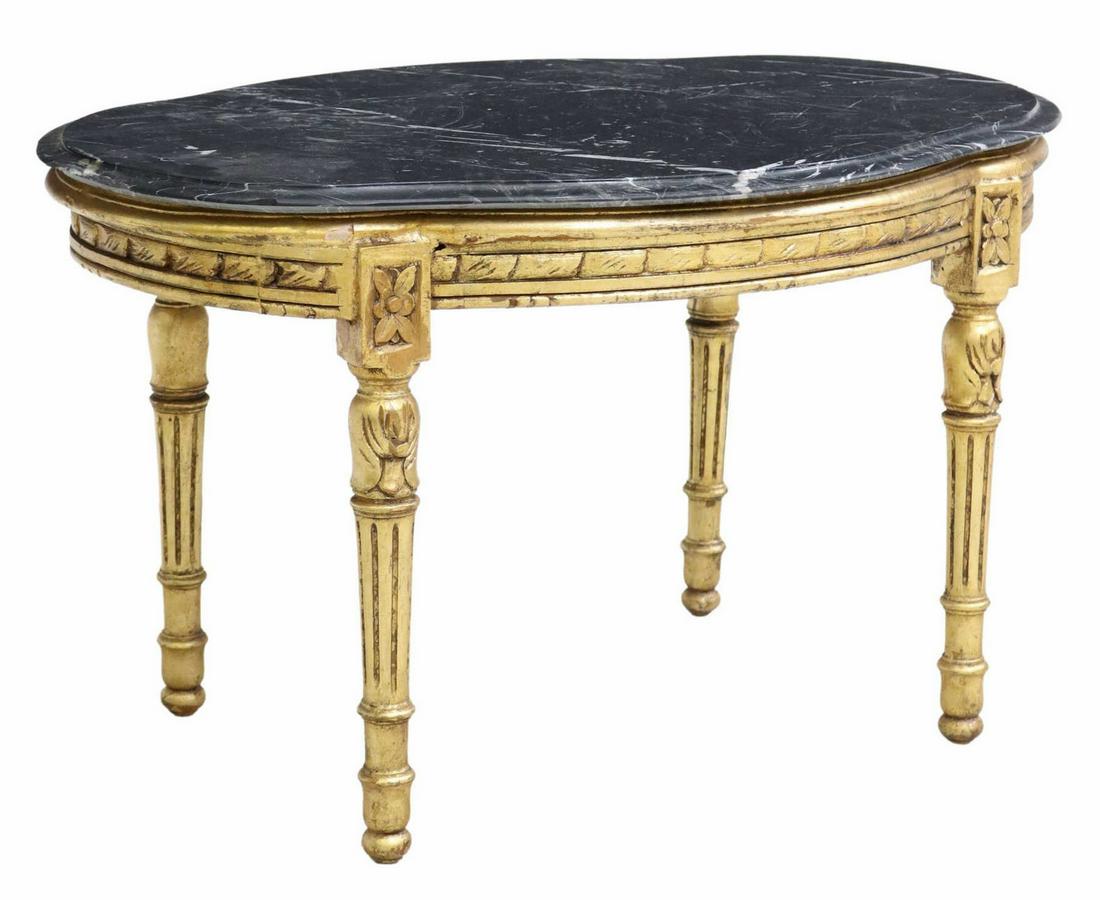 LOUIS XVI STYLE MARBLE-TOP GILTWOOD COFFEE TABLE: Louis XVI style giltwood coffee table, 20th c., a shaped marble top, rising on the giltwood base with tapered supports, chipping to edge of marble at one side as pictured, approx 19.5"h, 33.5"w, 22.5"