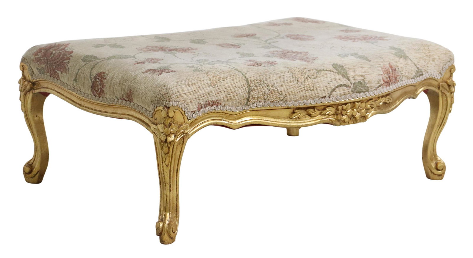 LOUIS XV STYLE GILTWOOD UPHOLSTERED FOOTSTOOL: Louis XV style giltwood ottoman/ footstool, 20th c., shaped seat, in a patterned upholstery, over floral apron, rising on cabriole legs, ending on whorl feet, approx 12.25"h, 31.75"w, 23"d Start Price