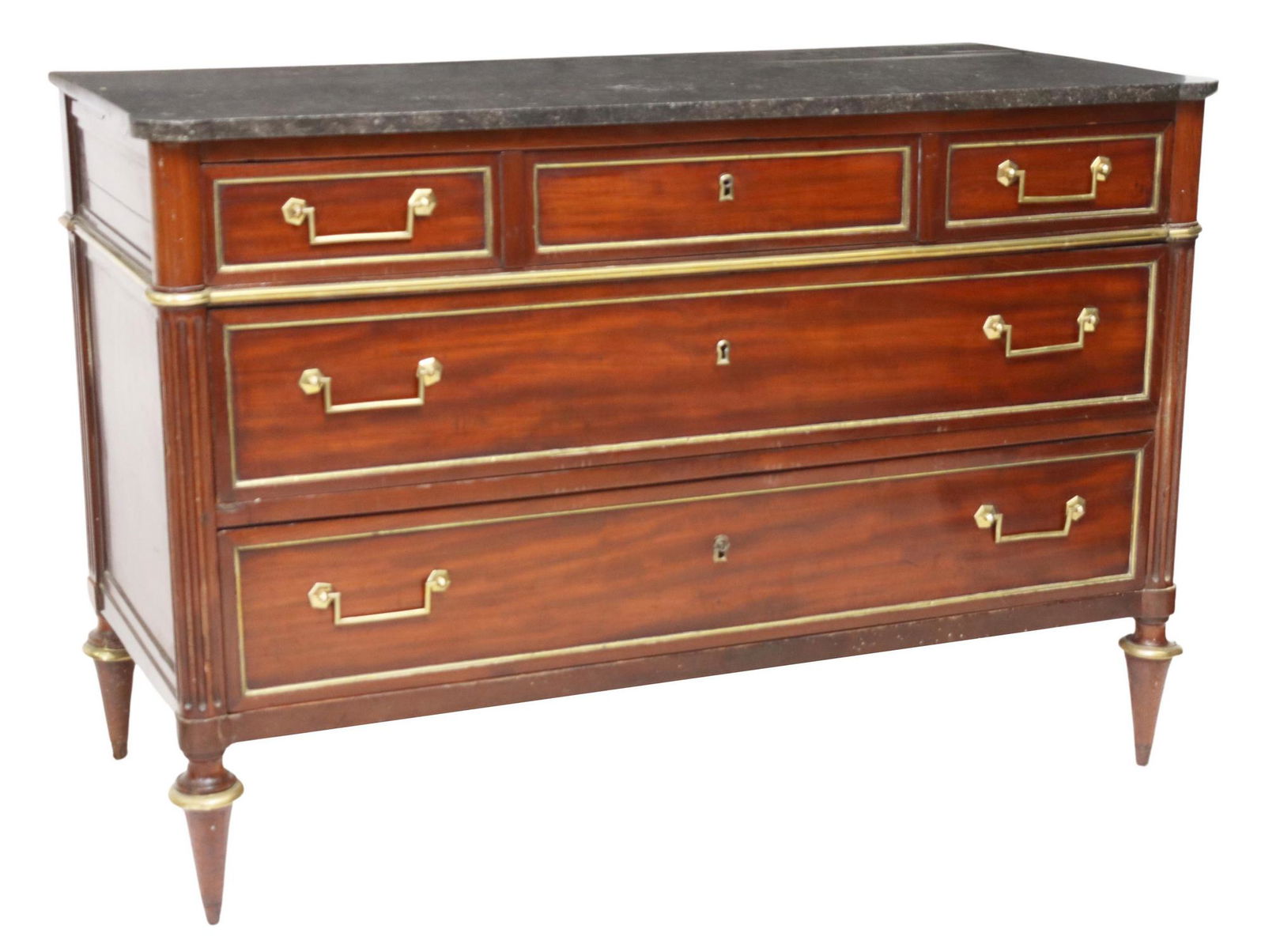 FRENCH LOUIS XVI STYLE MARBLE-TOP MAHOGANY COMMODE: French Louis XVI style marble-top mahogany commode, 19th c., three drawers with gilt metal trim, top drawer with divided interior, fluted corner posts, rising on tapered legs, separation at side panel