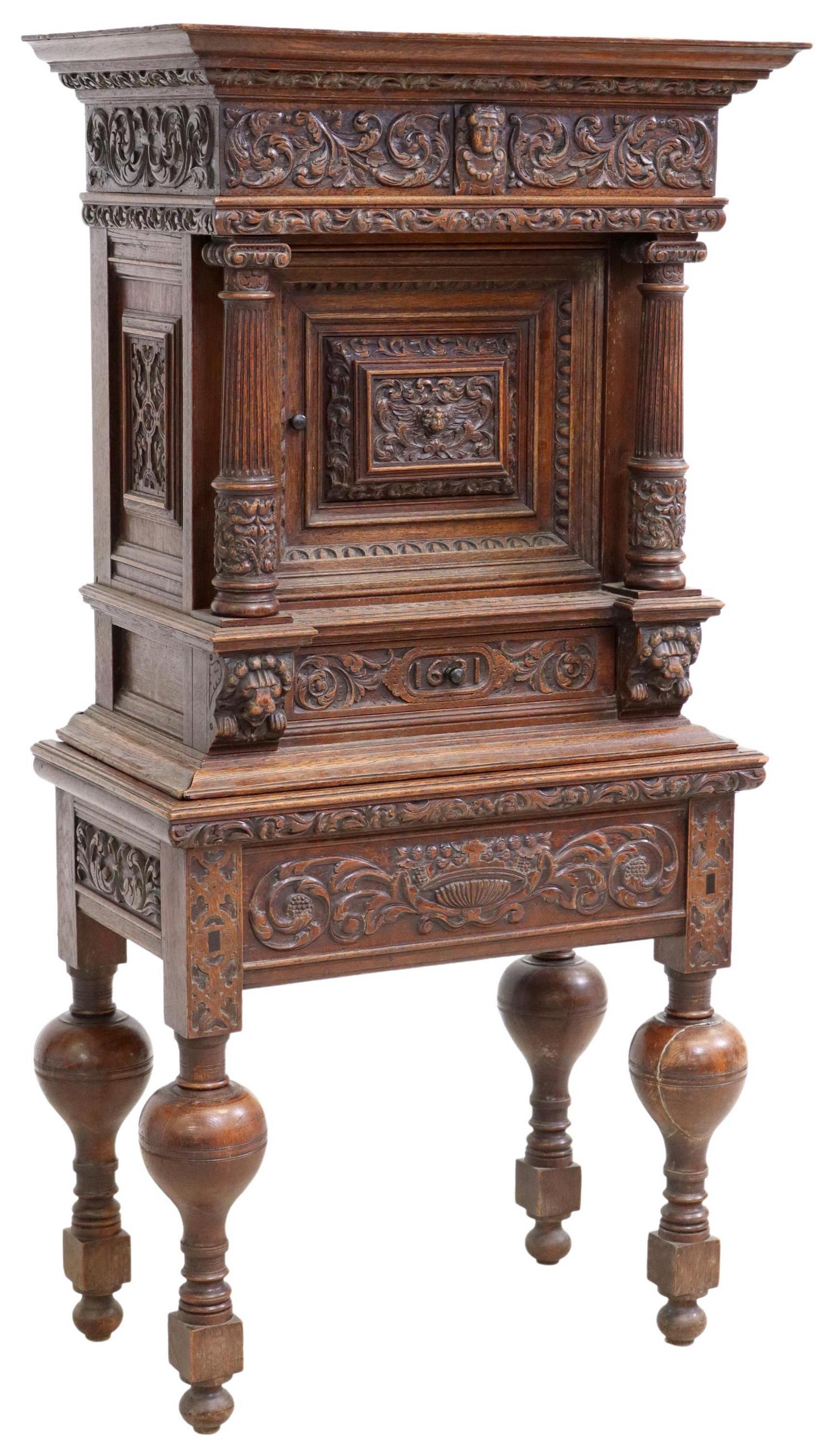 FRENCH FOLIATE CARVED OAK WINE CABINET: French carved oak wine cabinet, 19th c., the whole carved with foliates, having molded cornice, over coffered cabinet, flanked by fluted Corinthian column supports, single drawer marked 1631, rising o