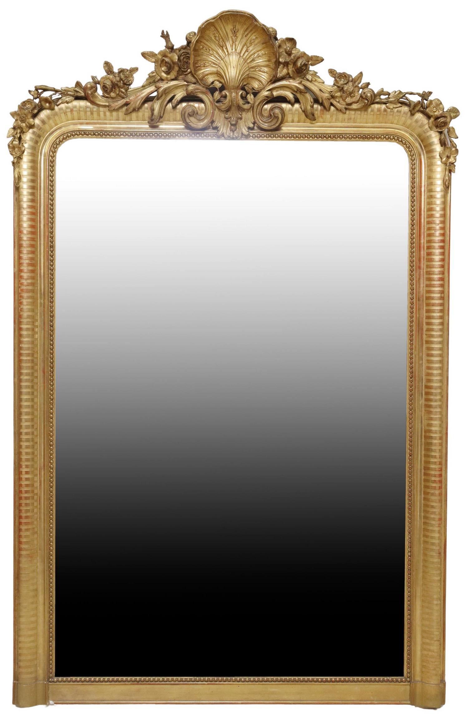 FRENCH LOUIS XV STYLE GILTWOOD WALL MIRROR: French Louis XV style giltwood wall mirror, early 20th c., having fanned crest with scrolled foliates and floral motifs, over molded frame with beaded trim, encasing flat mirror plate, typical small l
