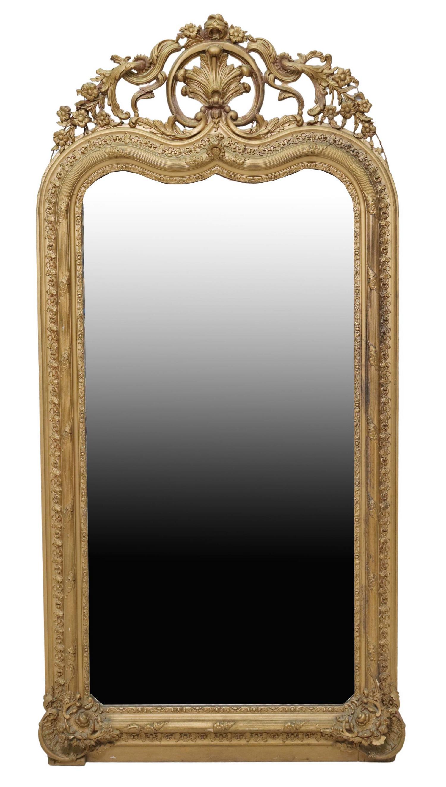 LARGE FRENCH CHARLES X PERIOD WALL MIRROR: Large French Charles X period wall mirror, 19th c., in a later gilt painted finish, having fanned crest with scrolled foliates and floral motifs, over shaped and molded frame, encasing flat mirror pla