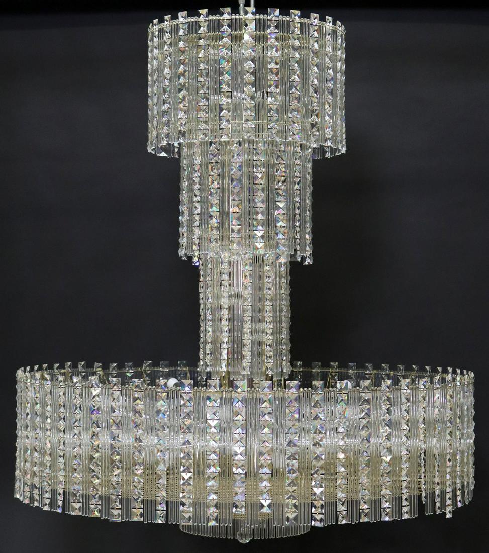 LARGE SCHONBEK MULTI-TIER CRYSTAL 72-LT CHANDELIER: Monumental Schonbek multi-tier crystal and gilt metal 72-light chandelier, late 20th c., having four-tier frame, hung with faceted crystal drops and cylindrical beads, partially assembled, accompanied