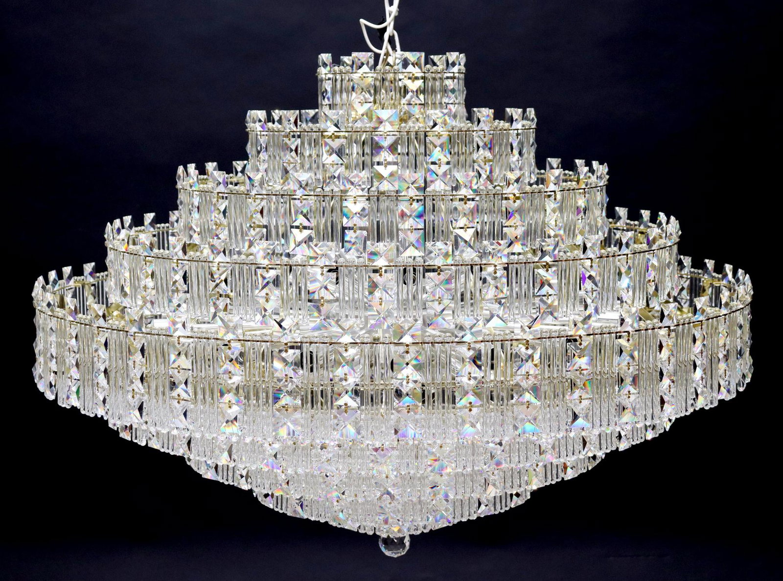 LARGE SCHONBEK MULTI-TIER CRYSTAL 43-LT CHANDELIER: Monumental Schonbek gilt metal and crystal multi-tier 43-light chandelier, late 20th c., having five graduated tiers, hung with faceted crystal beads and drops, over tapering base, terminating in sphe