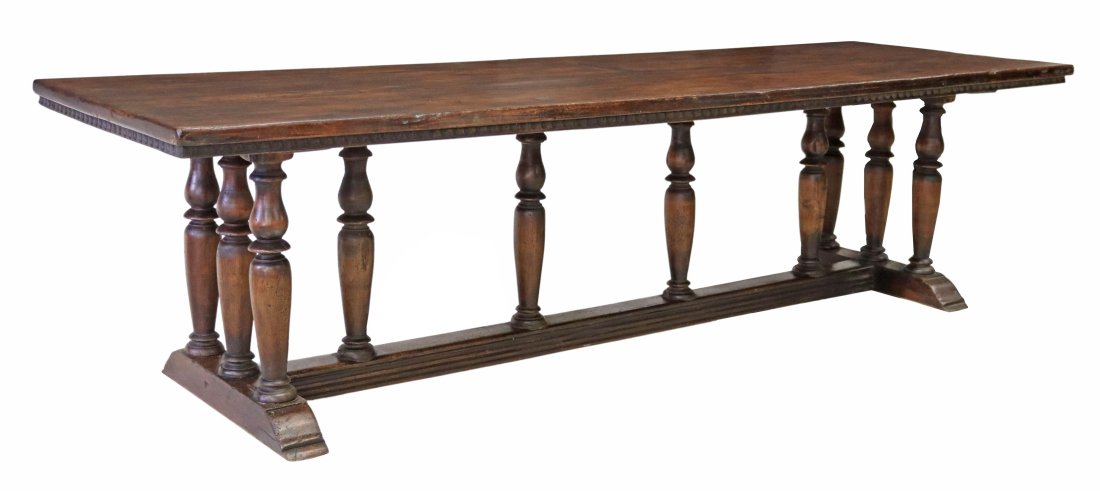 MONUMENTAL ITALIAN BAROQUE WALNUT REFECTORY TABLE: Italian Baroque walnut refectory table, 18thc, long hand hewed board top, over egg and dart carved apron, rising on turned colonnaded stretcher, ending on molded shoe base, retaining old patch repairs