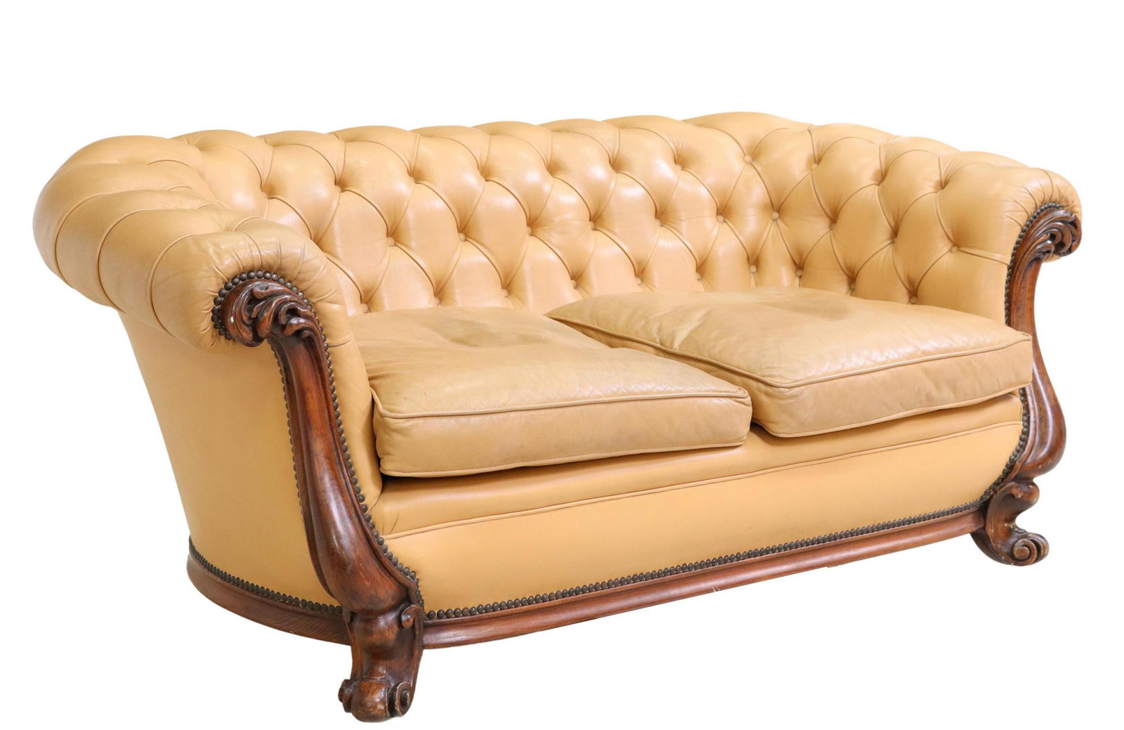 CHESTERFIELD STYLE TAN TUFTED LEATHER SOFA: Chesterfield style two-seat sofa, 20th c., in button-tufted tan leather upholstery, removable seat cushions, nailhead trim, rising on short cabriole legs, ending on whorl feet, some spotting, wear to 