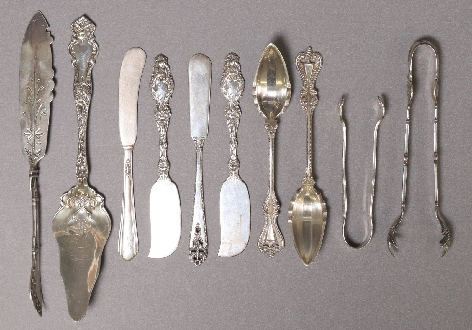 (10) ASSORTED AMERICAN STERLING FLATWARE, 10.7 OZT: (lot of 10) American sterling silver flatware, fruit spoons, sugar tongs, butter spreaders/ knives, etc., makers include: International, Towle Silversmiths, R. Wallace & Sons, Westmorland, Whiting Man
