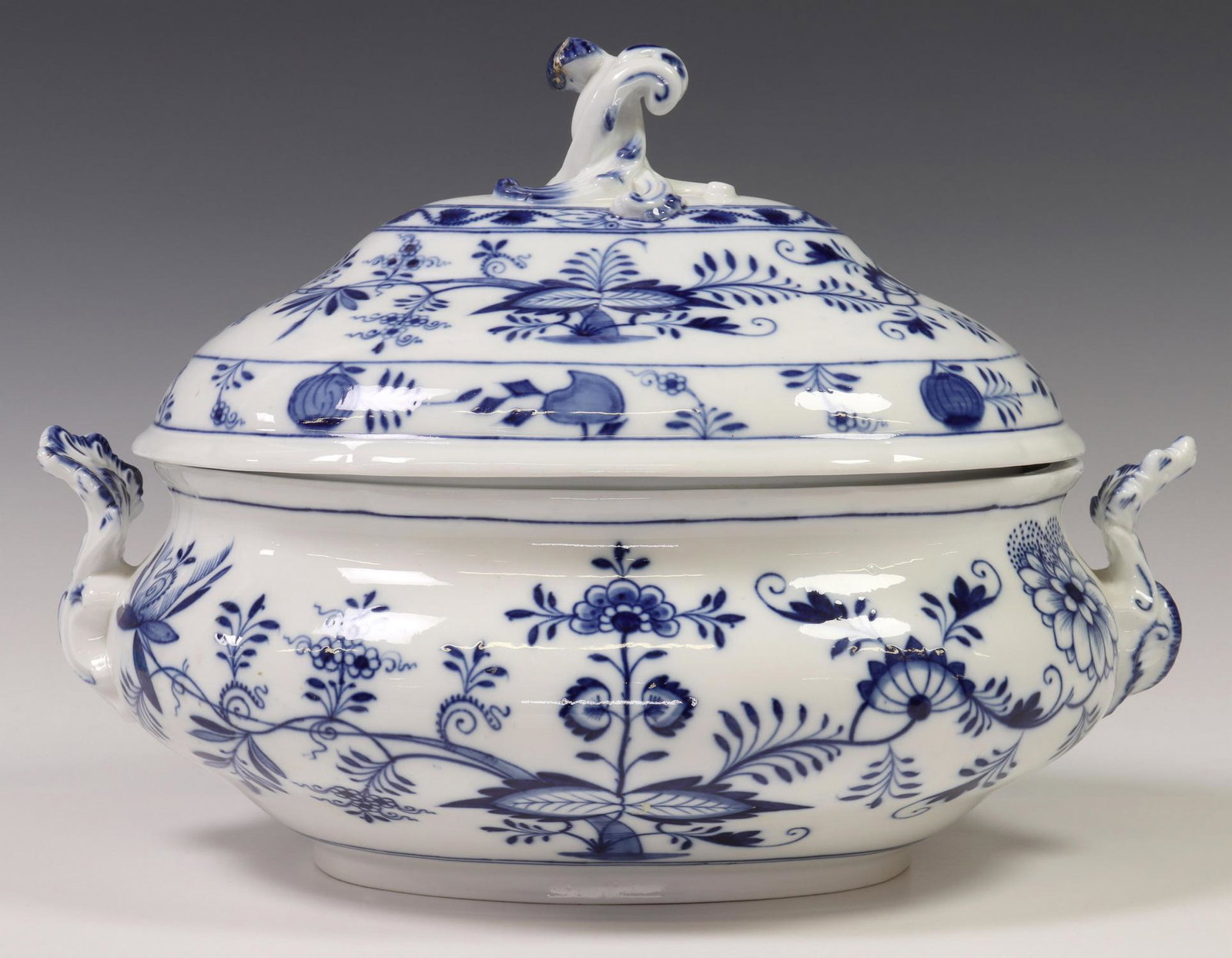 MEISSEN PORCELAIN 'BLUE ONION' LIDDED TUREEN: Meissen blue and white lidded tureen, in the "Blue Onion" pattern, with dual foliate handles, crossed swords mark underneath, restoration to lid finial, approx 10.25"h, 14"w, 9.75"d, 7.75lbs **Provena