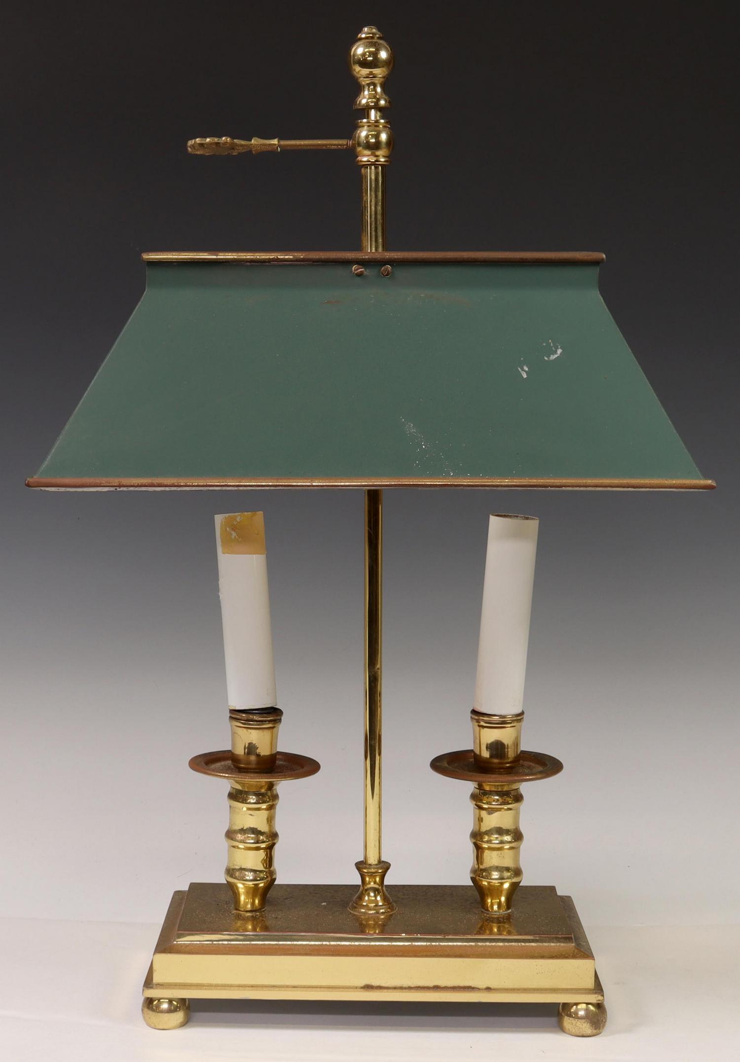 FRENCH GILT METAL BOUILLOTTE 2-LIGHT TABLE LAMP: French bouillotte table lamp, 20th c., having tole shade, over two turned-form standards, issuing faux candle covers, rising on rectangular plinth base, ending on ball feet, in need of wiring, metal w