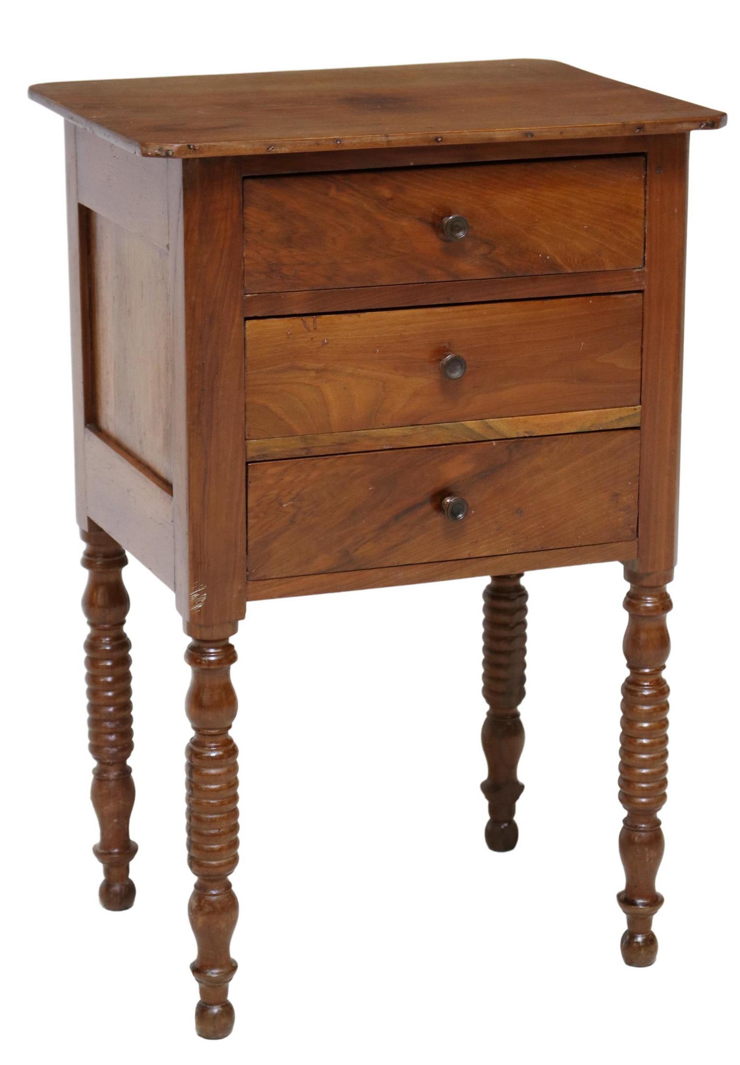 FRENCH WALNUT THREE-DRAWER TURNED LEG NIGHTSTAND: French walnut nightstand, early 20th c., having shaped top, over three drawers, lower drawer fitted with dual interior compartments, rising on turned legs, ending on rounded feet, approx 27.5"h, 18"w,