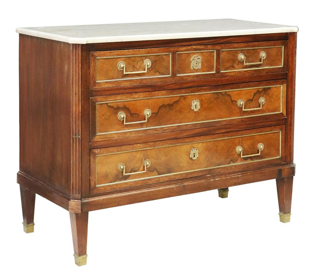 FRENCH LOUIS XVI STYLE MARBLE-TOP WALNUT COMMODE: French Louis XVI style walnut commode, 19th c., having shaped marble top, over three gilt-metal banded drawers, flanked by fluted side supports, rising on tapered legs, approx 32.5"h, 42.5"w, 19 5/8"d