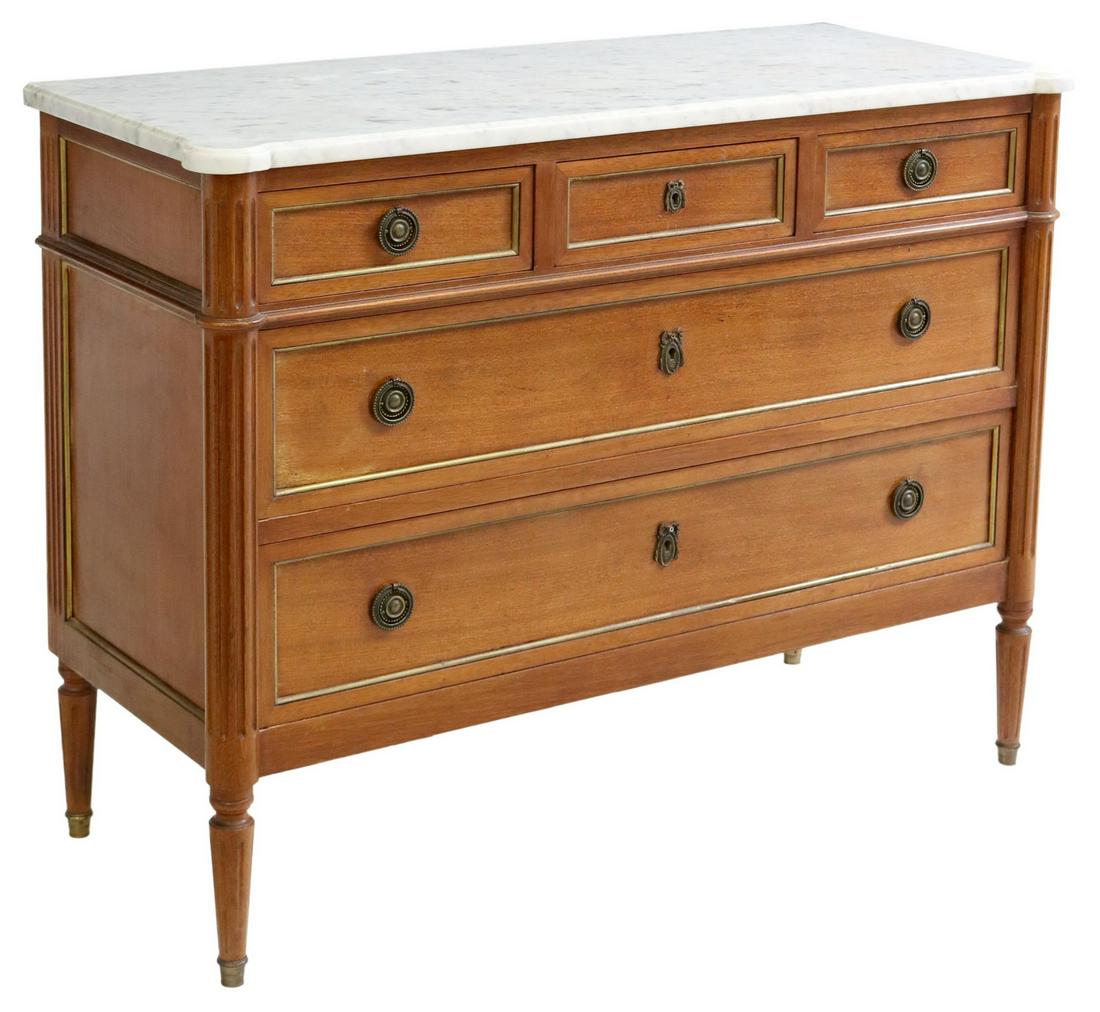 FRENCH LOUIS XVI STYLE MARBLE-TOP MAHOGANY COMMODE: French Louis XVI style marble-top mahogany commode, 20th c., three small drawers, over two long drawers, framed by fluted corner posts, rising on tapered legs, approx 33.5"h, 44.75"w, 18.5"d Start Pri