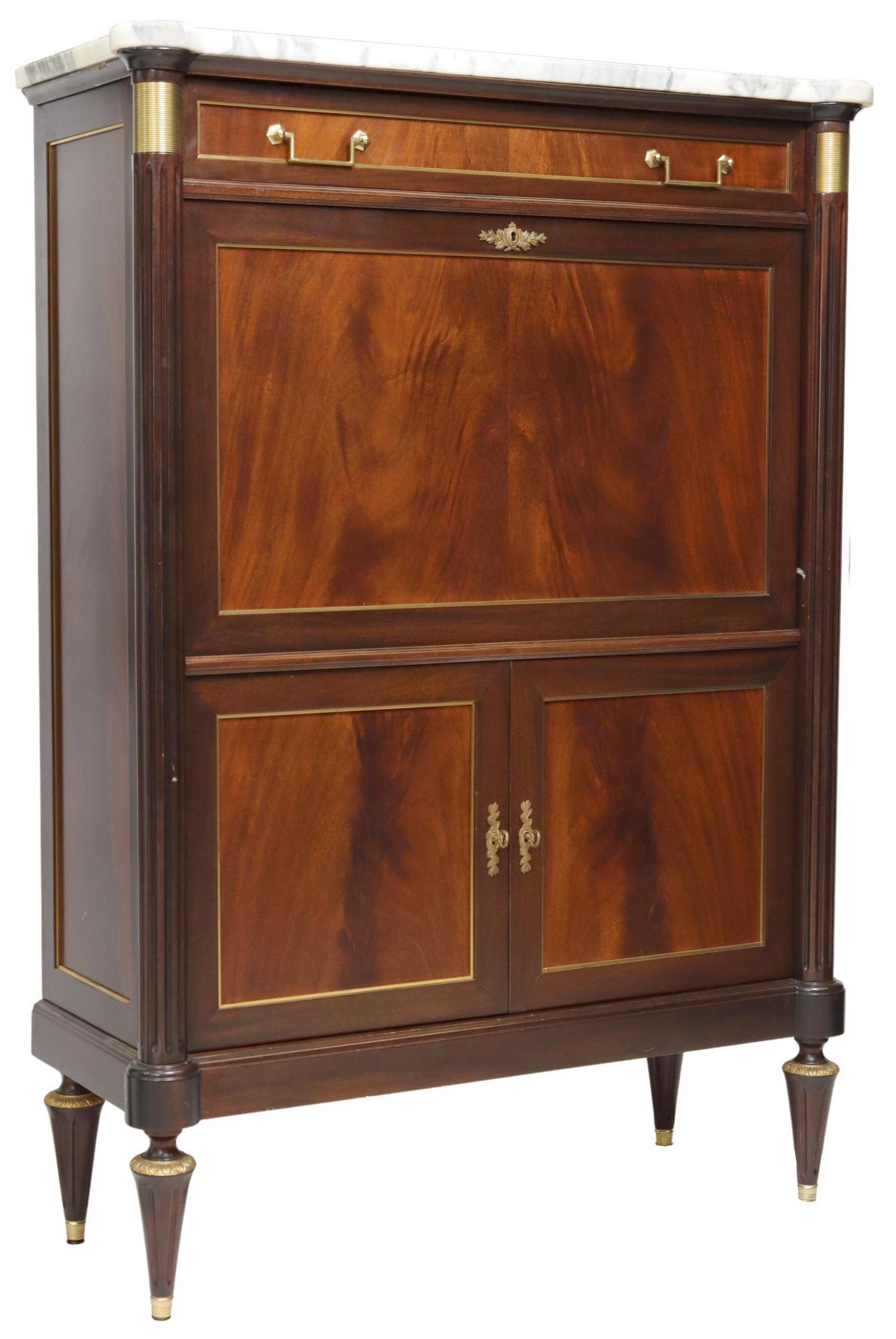 FRENCH LOUIS XVI STYLE FALL-FRONT BAR CABINET: French Louis XVI style flame mahogany bar cabinet, 20th c., having marble top, top drawer, over fall front, opening to mirrored interior, dual lower cabinets with faux key pulls, rising on fluted and 