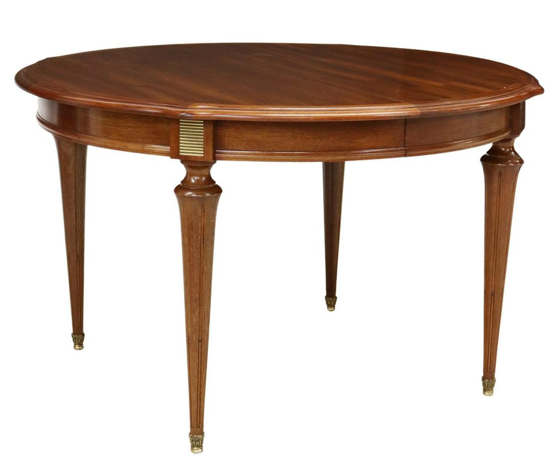 LOUIS XVI STYLE MAHOGANY EXTENSION DINING TABLE: French Louis XVI style mahogany dining table, 20th c., round tabletop, rising on tapering fluted legs, accompanied by (two) 19.5" leaves, approx 29.25"h, 48.5"diam Start Price: $150.00