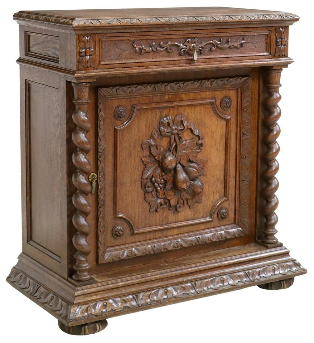 FRENCH HENRI II STYLE CARVED OAK SERVER/ CABINET: French Henri II style oak server, 19th c., top with lunette border, single drawer, over cabinet faced with carved fruits, flanked by twist side supports, ending on carved feet, approx 39.5"h, 38.25"w,