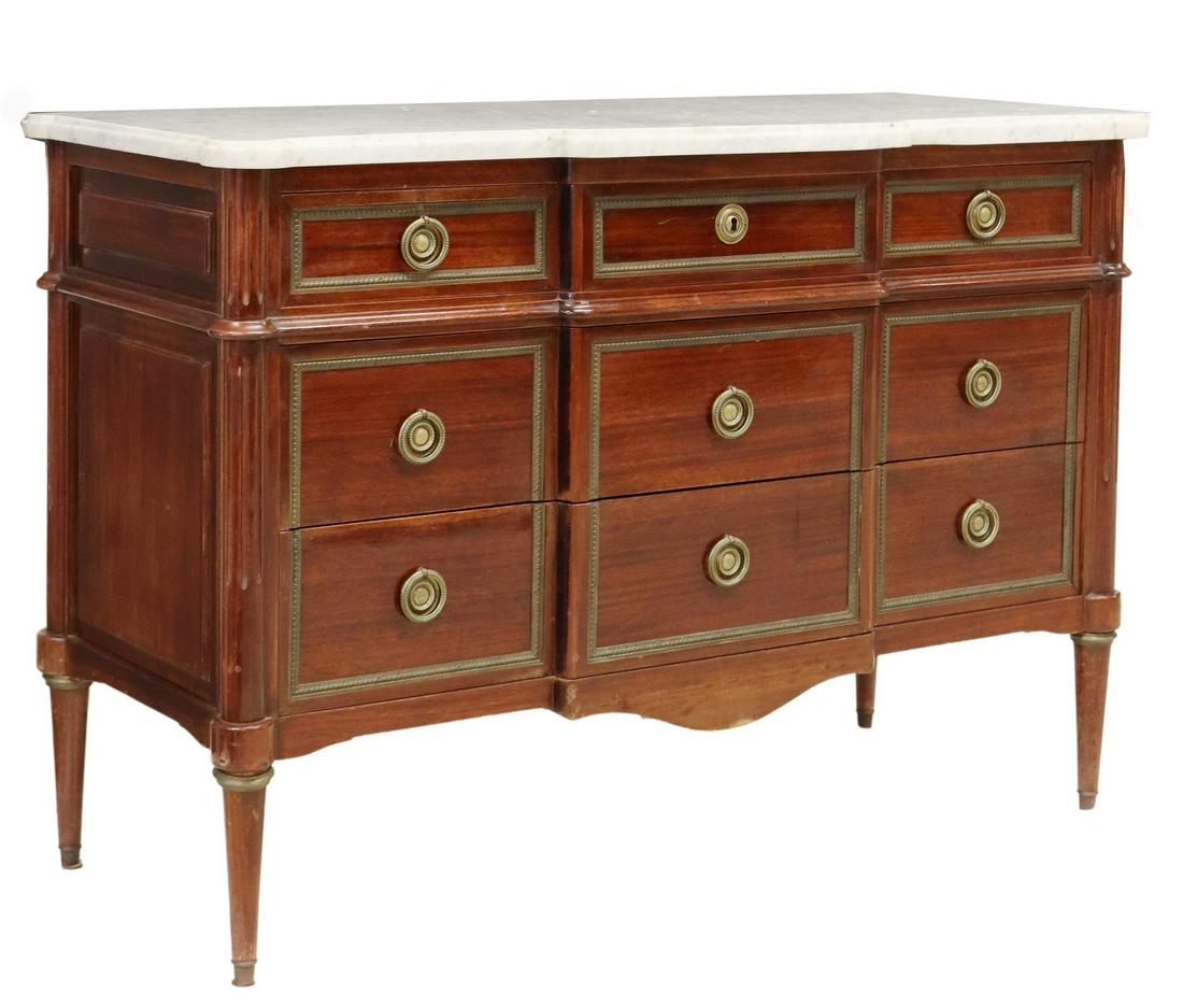 FRENCH LOUIS XVI STYLE MARBLE-TOP MAHOGANY COMMODE: French Louis XVI style marble-top mahogany commode, 20th c., breakfront case fitted with three drawers, flanked by fluted corner posts, rising on tapered legs, approx 35.5"h, 52.25"w, 21.5"d Start Pri