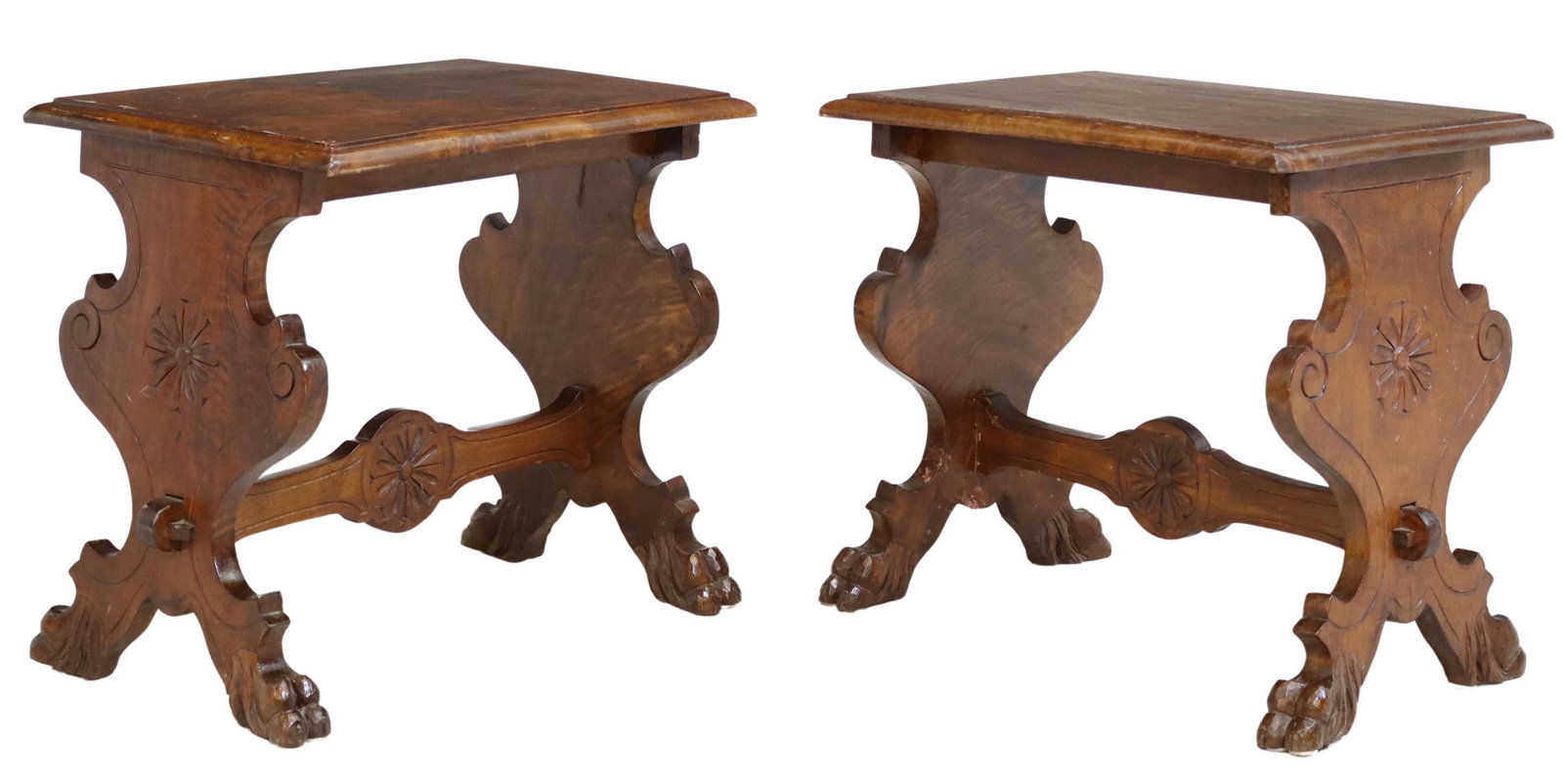 (2) ITALIAN RENAISSANCE REVIVAL CARVED STOOLS: (pair) Italian Renaissance Revival carved walnut stools, early 20th c., having rectangular top, rising on trestle base, joined by H stretcher with central floral medallion, ending on paw feet, approx 