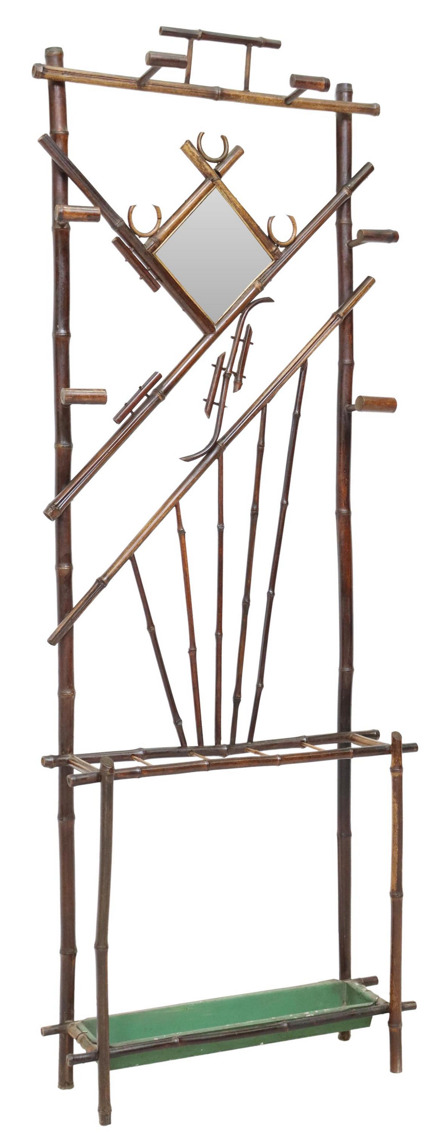 VICTORIAN AESTHETIC MOVEMENT BAMBOO HALL TREE: Victorian Aesthetic Movement bamboo hall tree, late 19th/ early 20th c., fretwork back with hooks, beveled mirror plate, walking stick/ umbrella rail with inset tray, approx 76"h, 27.75"w, 8.5"d Start