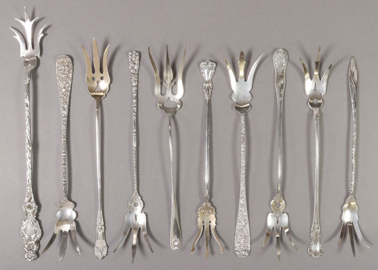 (10) COLLECTION OF STERLING SILVER LETTUCE FORKS: (lot of 10) Sterling silver lettuce service forks, varied makers and patterns, highlights include: (2) Steiff 'Repousse', (1) Gorham 'Buttercup', (1) in a Cattail pattern, possibly Durgin, (1) Silverc