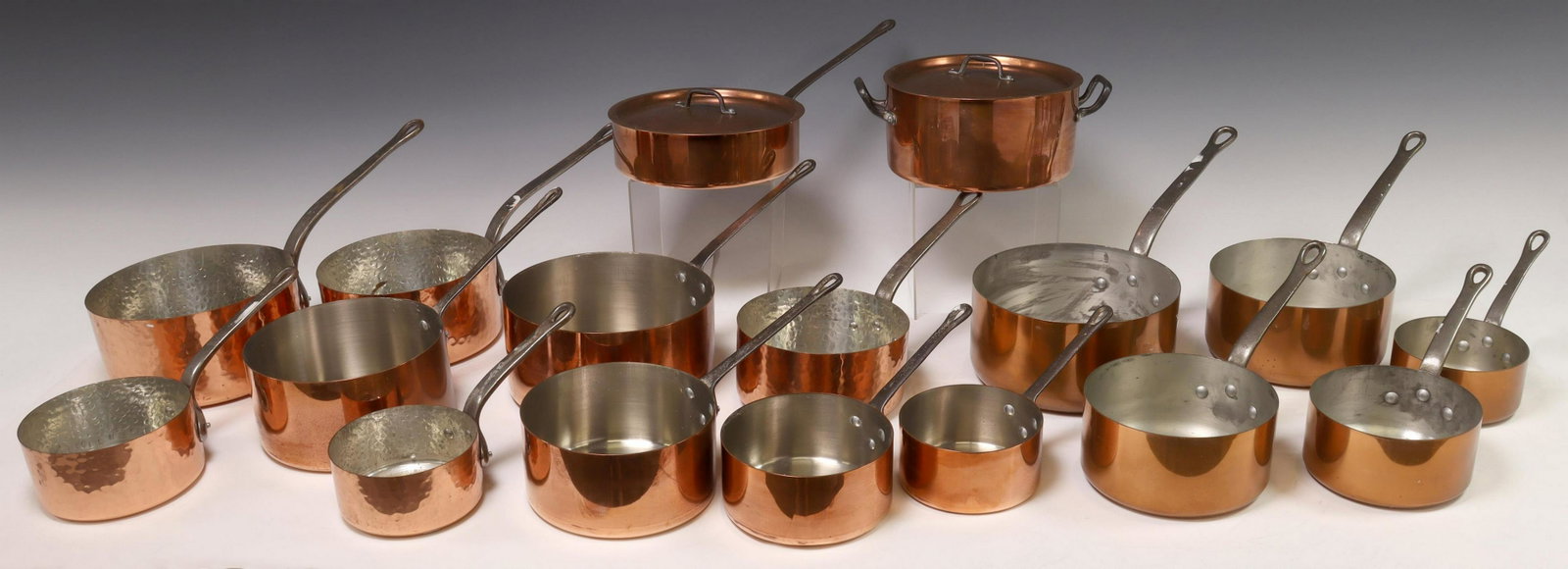 (17) FRENCH COPPER GRADUATED SAUCEPANS & POTS: (lot of 17) French copper kitchenware, each with iron handle, including: (5) graduated saucepans, Les Cuivres de Faucogney, maker's mark at side, largest: approx 4"h, 15"w, 8"d; (5) graduated saucepan
