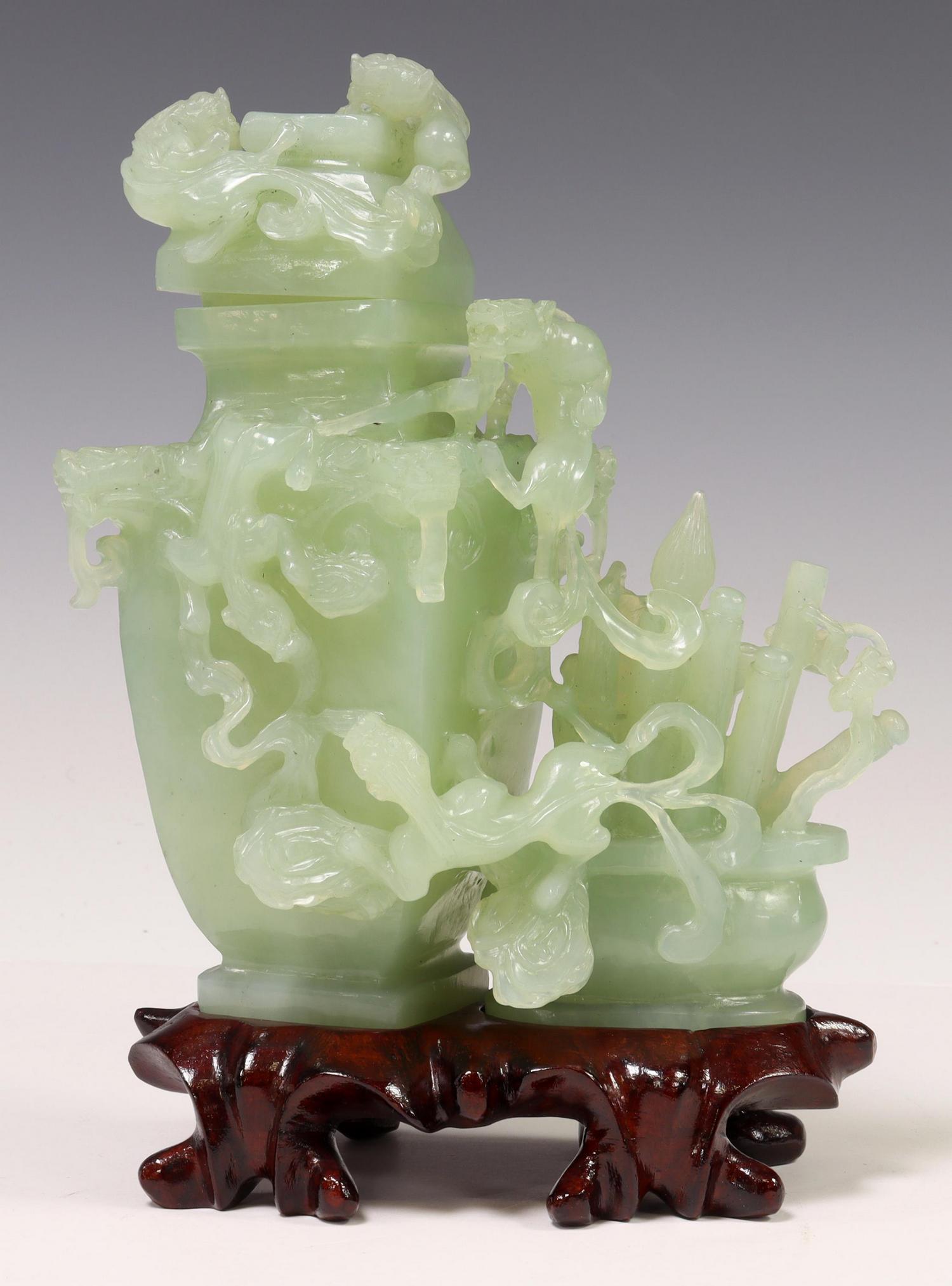 CHINESE CARVED GREEN HARDSTONE COVERED VASE GROUP: Chinese carved green hardstone ornament, lidded vase with chilongs/ dragons, flanked by a scholar's brush pot, on a carved wood stand, approx 8"h, 5.5"w, 3"d, 2.5lbs Start Price: $60.00