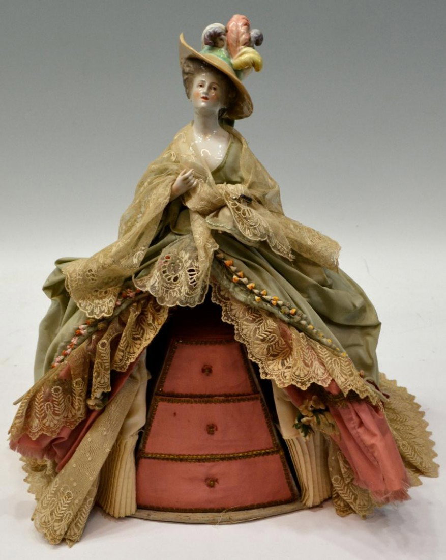 UNUSUAL CHINA HEAD DOLL LACE GOWN JEWELRY BOX: Unusual vintage figural jewelry box, china head top of a beauty wearing feathered hat, her lace and gown trimmed with flowers, concealing a jewel box of three graduated drawers, loss of thumb on one h