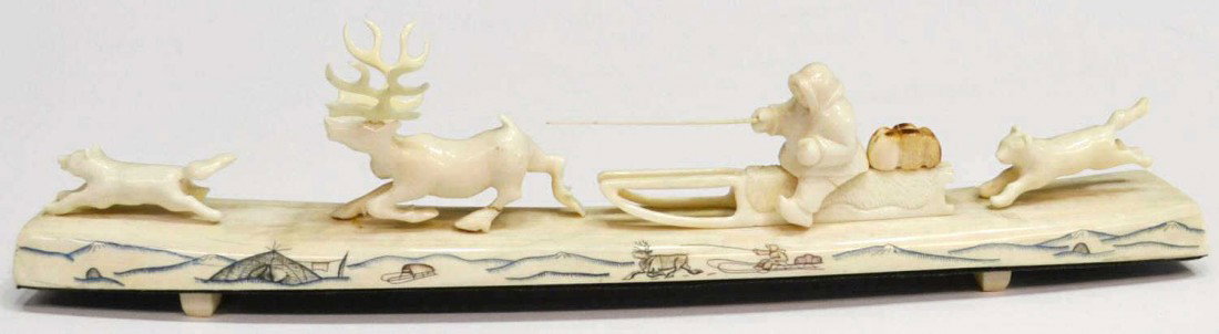 LARGE INUIT WALRUS TUSK IVORY CARVING, SLED DOGS: Inuit carved walrus ivory figural group, Eskimo on sled with removable whip following reindeer, husky with one husky following behind, all atop a long narrow piece of walrus ivory with drawing of Eski