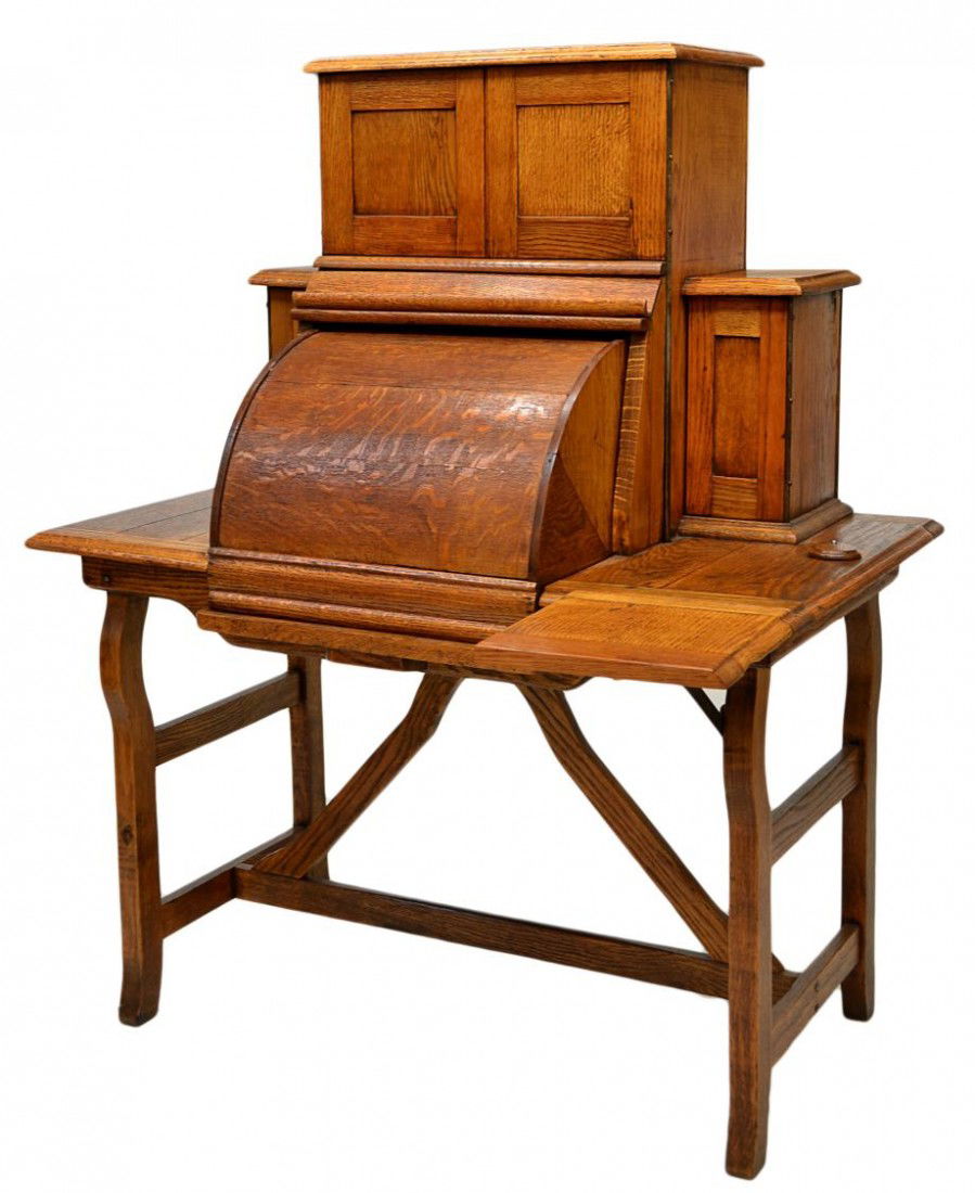 ANTIQUE AMERICAN MECHANICAL OAK CYLINDER DESK: American mechanically operated quarter sawn oak desk, c. 1880, two doors and a drawer over a cylinder roll flanked by doors, all set on a table with drop leaf writing surface at one side, pulling out