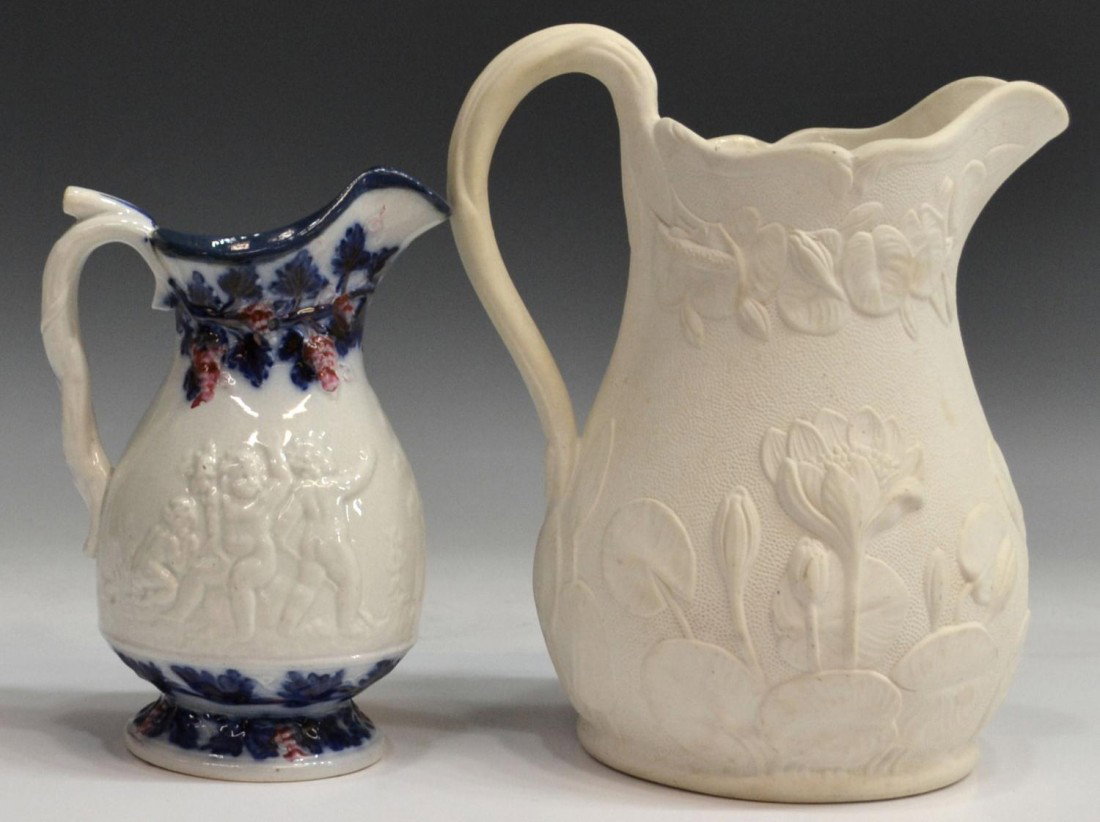 (2)BENNINGTON 'POND LILY' PARIAN & FLOW BLUE JUGS: (lot of 4) Molded relief jugs, including: (1) scarce Bennington jug, mid 19th c., Pond Lily pattern, embossed ribbon mark. Lyman Fenton & Co., Bennington, Vt., 8.75"h; (1) smaller pitcher showing putt