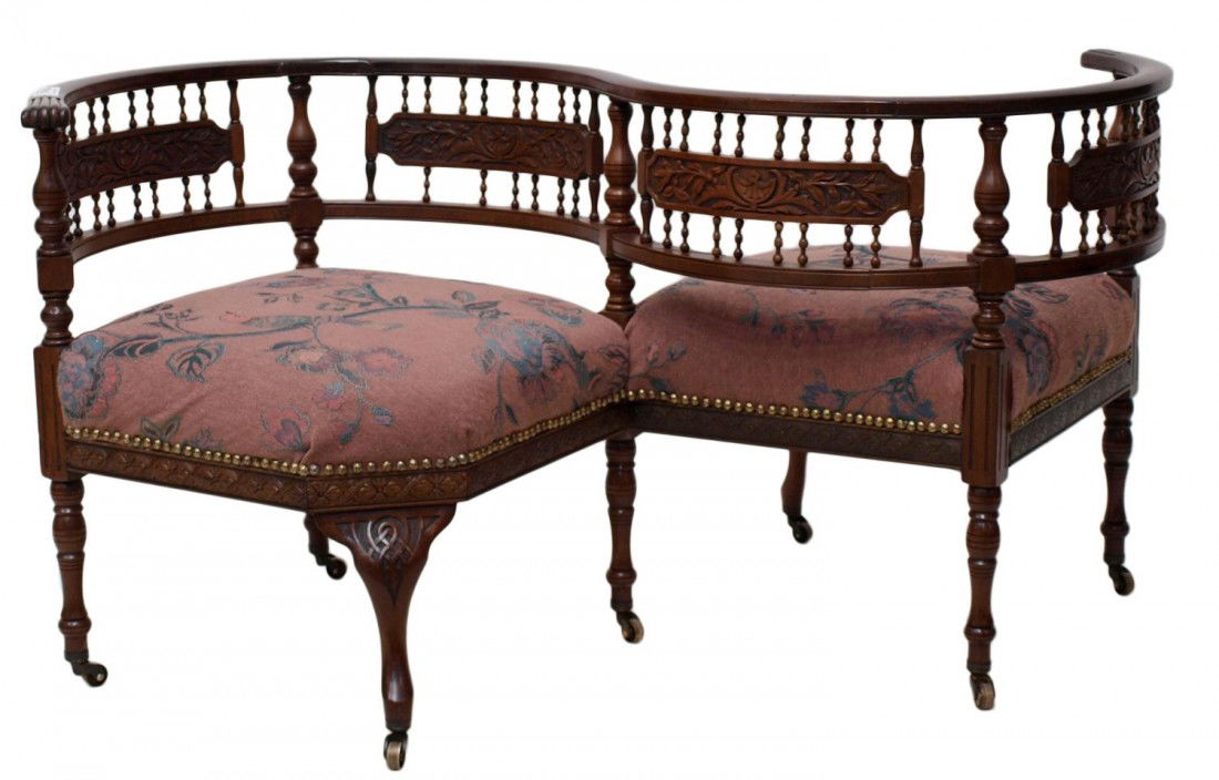 ANTIQUE BENTWOOD TETE-A-TETE CONVERSATION SOFA: Antique mahogany framed tete-a-tete, Continental, 19th c., bentwood rail and frame with spindle supports and three foliate carved panels, later upholstery, rising on turned and cabriole legs with cast