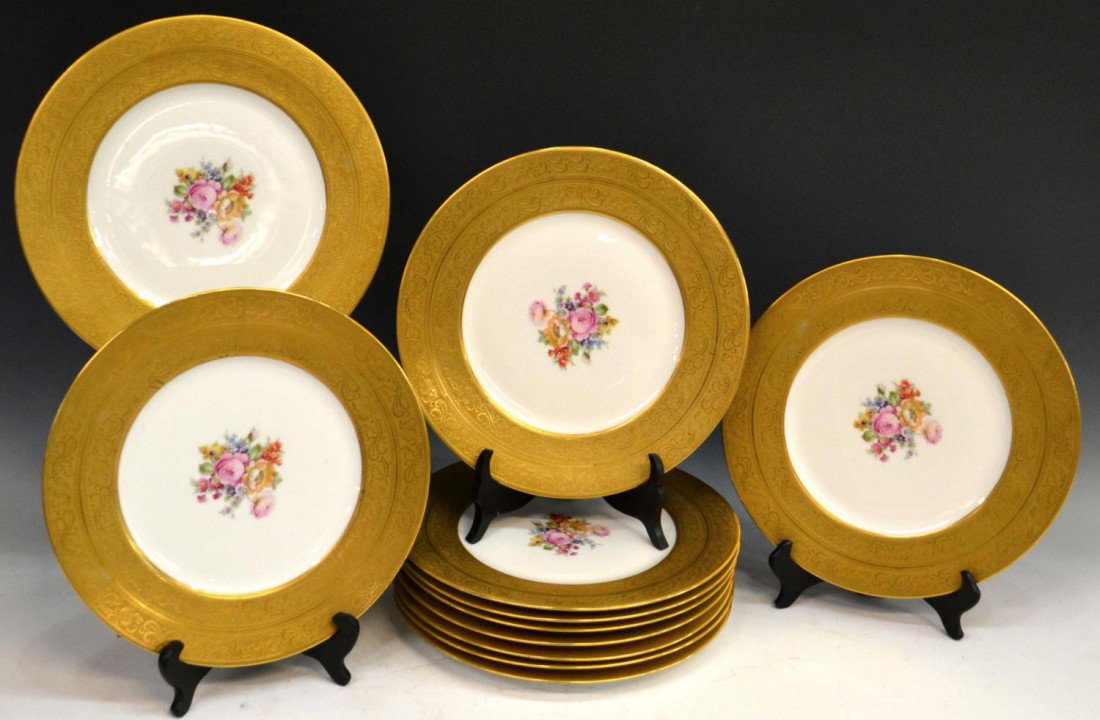 HEAVILY GILDED & ETCHED PORCELAIN CABINET PLATES: (lot of 11) Heavily gilded porcelain cabinet plates, with wide gilded and etched scrolling foliate boarders, on white ground, centered by transferred floral motifs, unmarked, some with minor pitting a