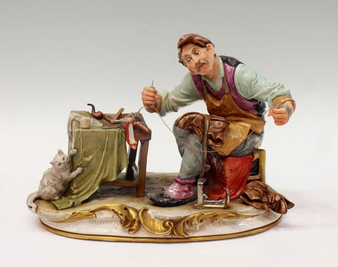 LARGE CAPODIMONTE PORCELAIN 'COBBLER', B. MERLI: Large Italian porcelain figural group signed B. Merli, The Cobbler, retaining gallery tag on back, marked with crown over N, some loss of gilding along base, some pits/flakes, 9.5"h, 13"l, 7"w, 6.5lbs